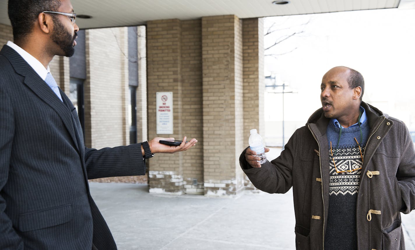 Jaylani Hussein, left, executive director of the Council on American-Islamic Relations, Minnesota chapter (CAIR), and Omar Jamal argue about talking to the media after a press conference held by members of the local Muslim and Somali community to raise concerns about the Department of Justice's new pilot program to counter violent extremism on Tuesday, February 17, 2015. Omar Jamal supports the pilot program. ] LEILA NAVIDI leila.navidi@startribune.com /