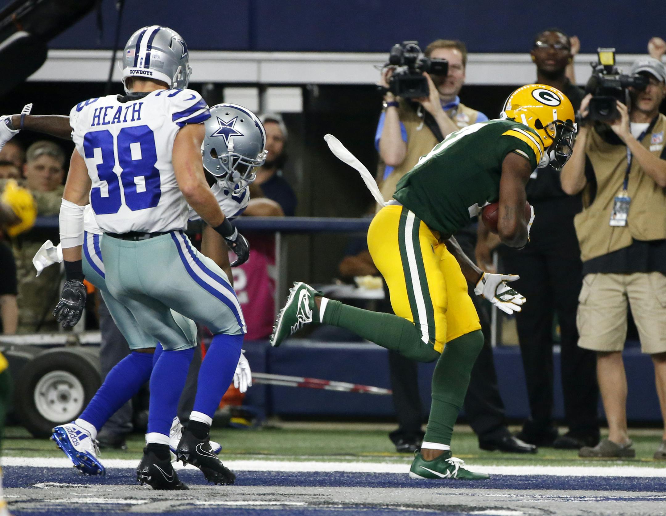 Dallas Cowboys safety Jeff Heath (38) watches as Green Bay Packers wide receiver Davante Adams (17) catches a touchdown pass late in the second half of an NFL football game, Sunday, Oct. 8, 2017, in Arlington, Texas. (AP Photo/Michael Ainsworth)