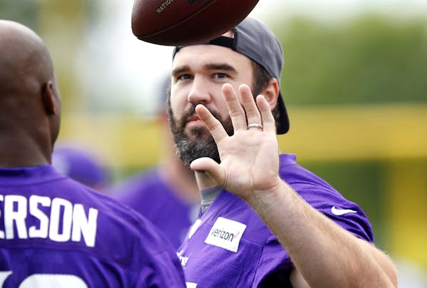 Vikings center John Sullivan talked with running back Adrian Peterson during the start of training camp.