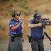 Jonah Klevesahl fired on targets with an AR-15 while he was monitored and timed by Gunnar An during 3 gun league competition Wednesday night. ] JEFF W