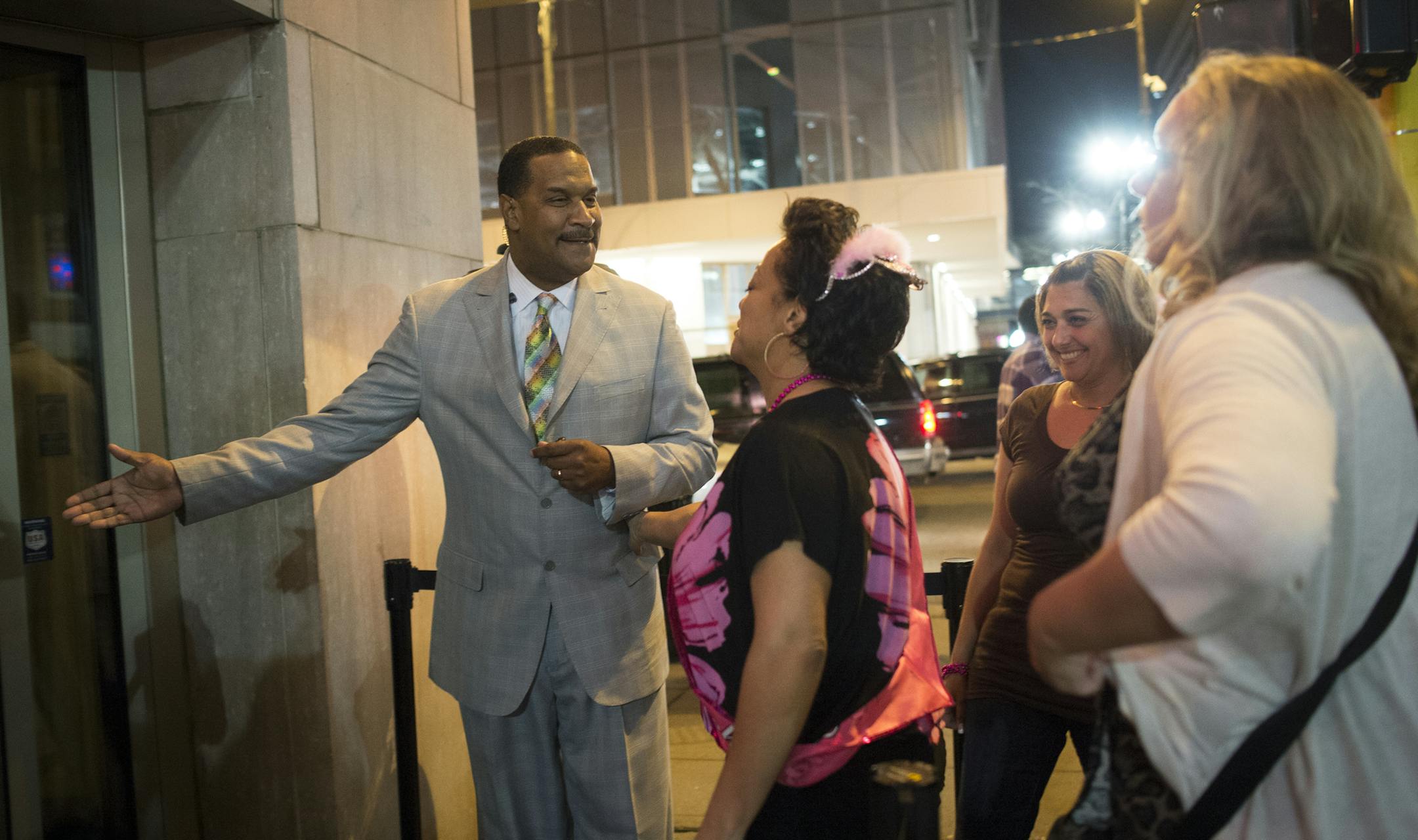 Doorman Bryant Webster greeted customers at Seven Steakhouse in downtown Minneapolis on a recent Saturday night. Below, he waited outside the club with fellow doorman Theryl Dugas.