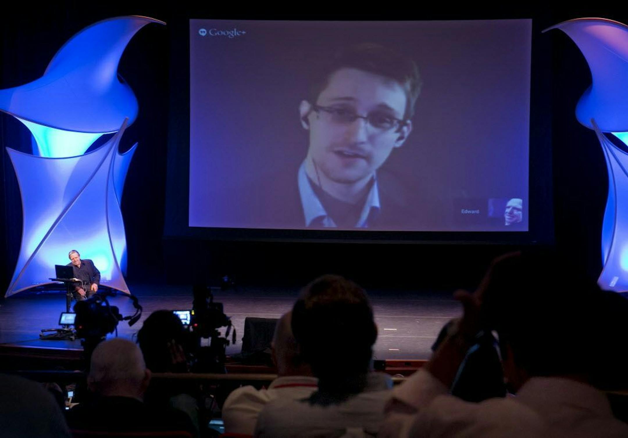 FILE - In this June 5, 2014 file photo, former NSA contractor Edward Snowden participates in a conversation via video with John Perry Barlow, co-founder & vice chairman of the Electronic Frontier Foundation, at the 2014 Personal Democracy Forum, at New York University in New York.