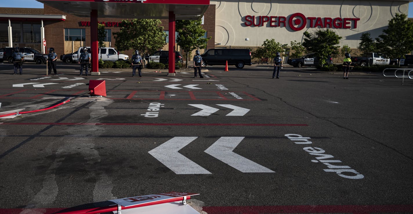 The Target on the Midway was secured by a heavy police presence. Several buildings near the MIdway were either damaged or set on fire. Protesters in St. Paul near Target clashed with police on the third day..]RICHARD TSONG-TAATARII ¥ richard.tsong-taatarii@startribune.com