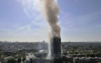 Smoke billows from a fire that has engulfed the 24-storey Grenfell Tower in west London, Wednesday June 14, 2017. Fire swept through a high-rise apart