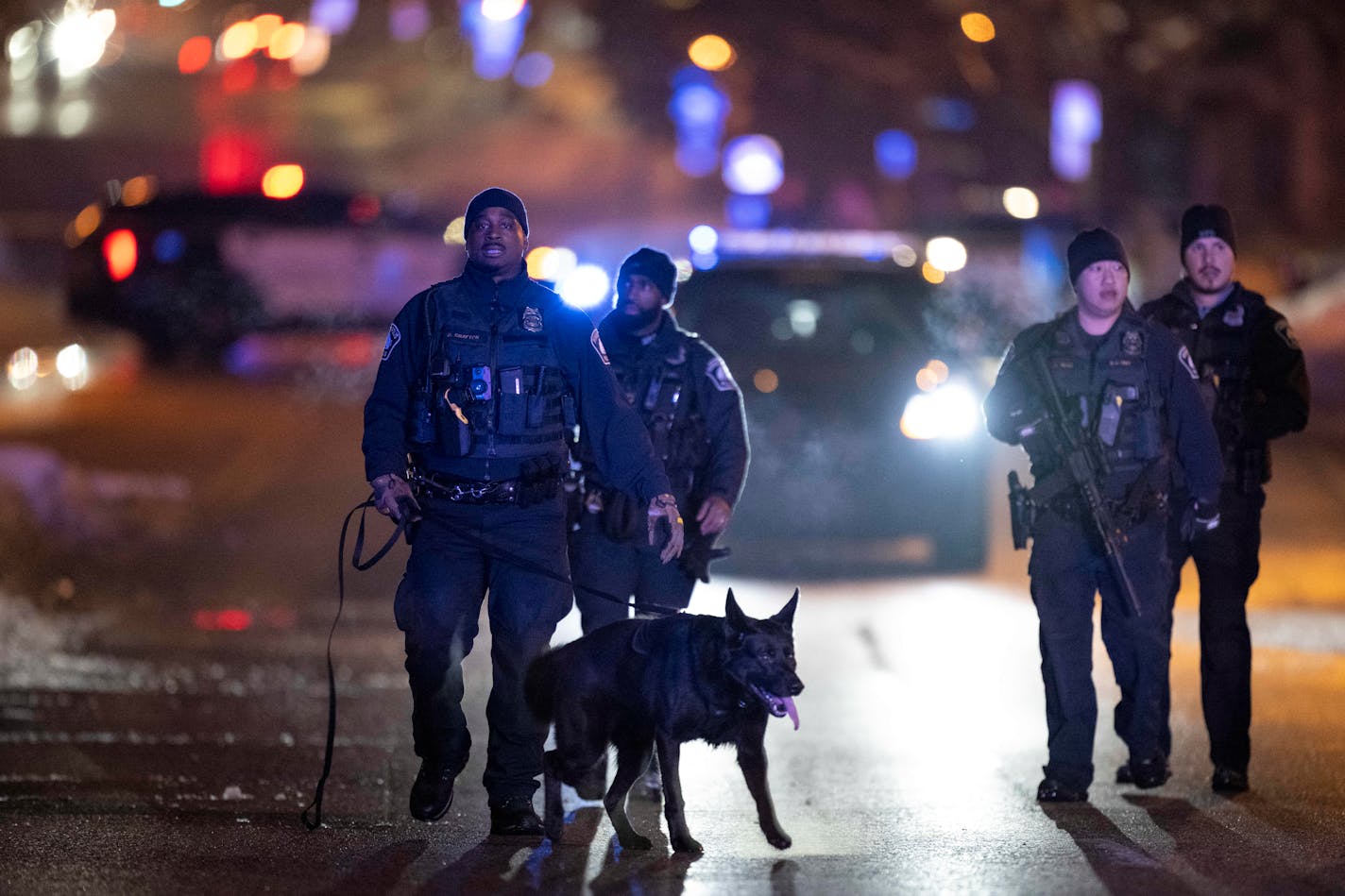 A group of Minneapolis officers with a police dog K-9 walked near the scene of a fatal shooting Wednesday, Jan. 11, 2023 near Star Foods on the 800 block of Lowry Avenue North in Minneapolis, Minn.. ] AARON LAVINSKY • aaron.lavinsky@startribune.com