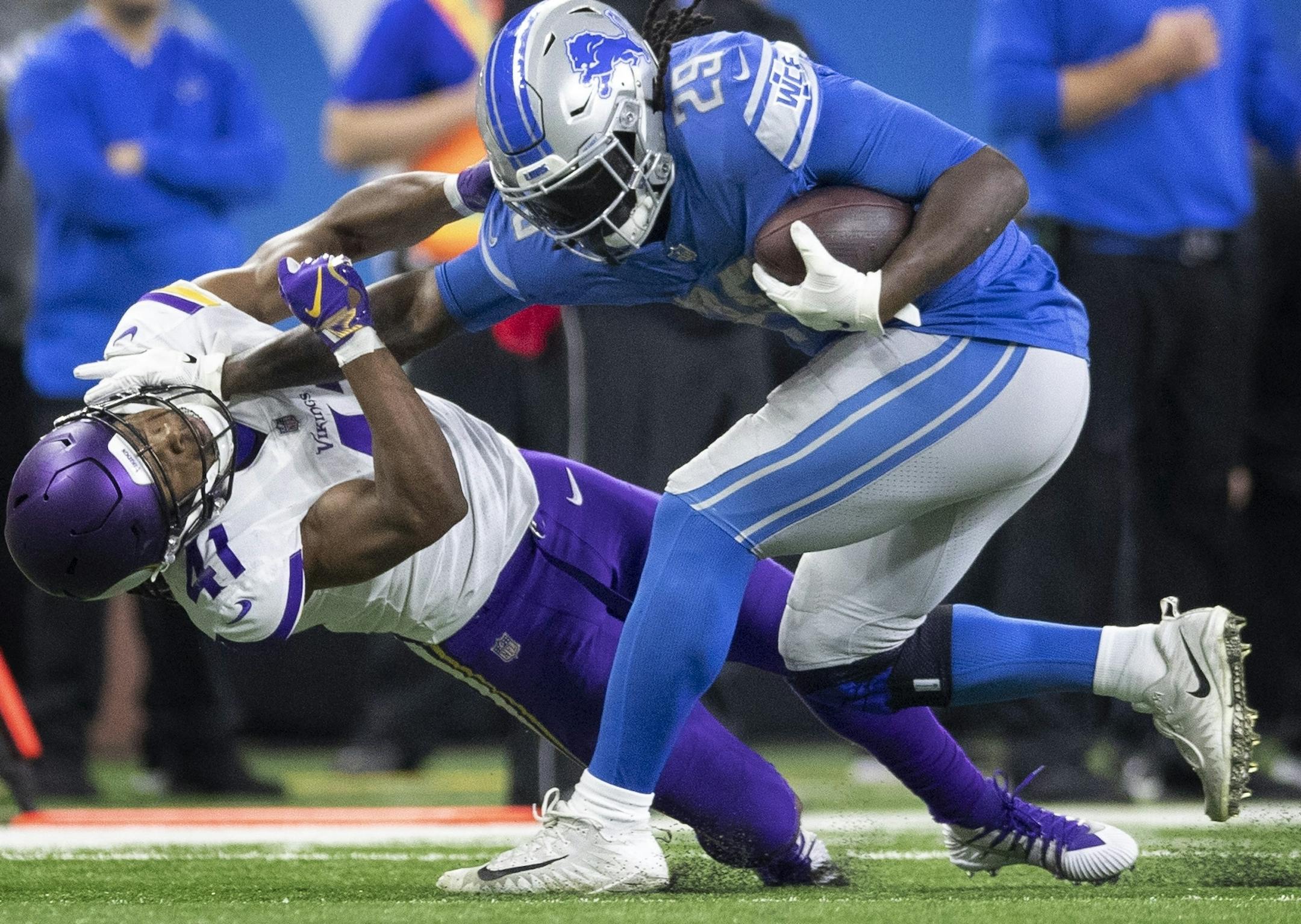 Detroit Lions running back LeGarrette Blount (29) stiff armed Minnesota Vikings defensive back Anthony Harris (41) for a first down in the forth quarter at Ford Field Sunday December 23, 2018 in Detroit, MI.