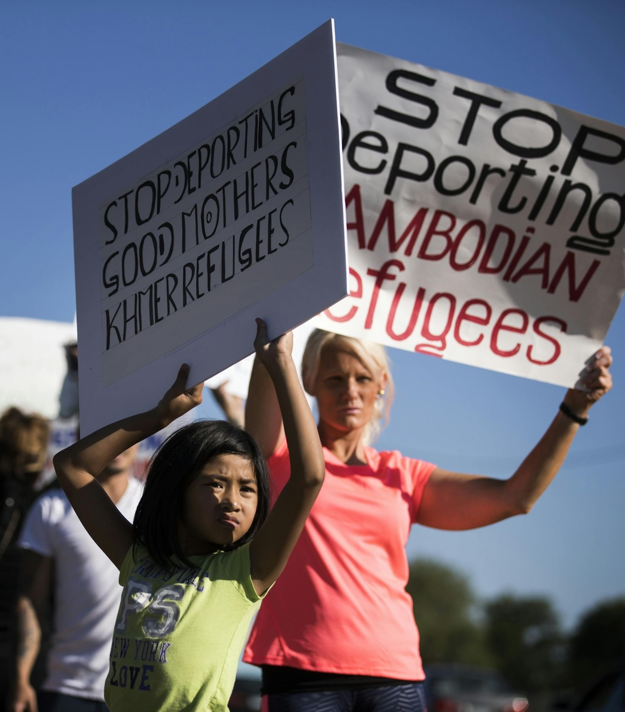 Alexis Chum, 10, of Rosemount holds a sign during the rally.