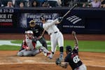 The Yankees' Aaron Judge follows through on a three-run triple against Twins reliever Diego Castillo during the fifth inning Wednesday night.