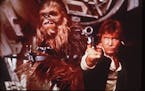 Harrison Ford, right, as Han Solo and Peter Mayhew as Chewbacca in an image from the 1977 release of "Star Wars."