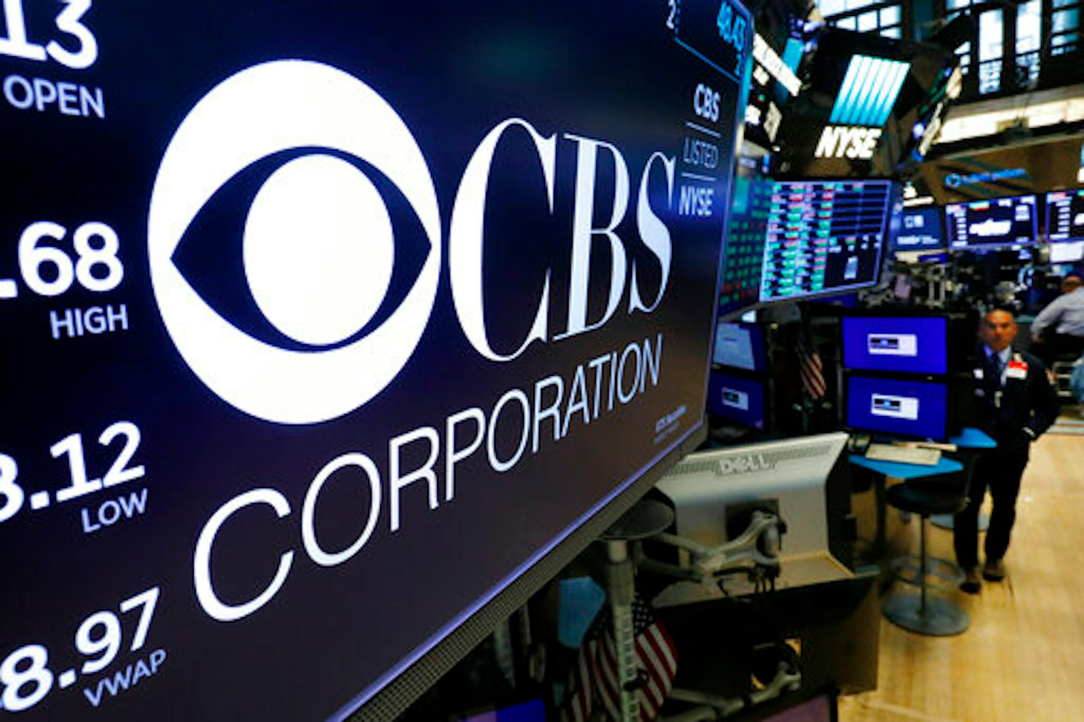 The logo for the CBS Corporation appears above a trading post on the floor of the New York Stock Exchange, Tuesday, Aug. 13, 2019. CBS and Viacom said Tuesday they will reunite, bringing together their networks and the Paramount movie studio as traditional media giants bulk up to challenge streaming companies like Netflix. (AP Photo/Richard Drew)