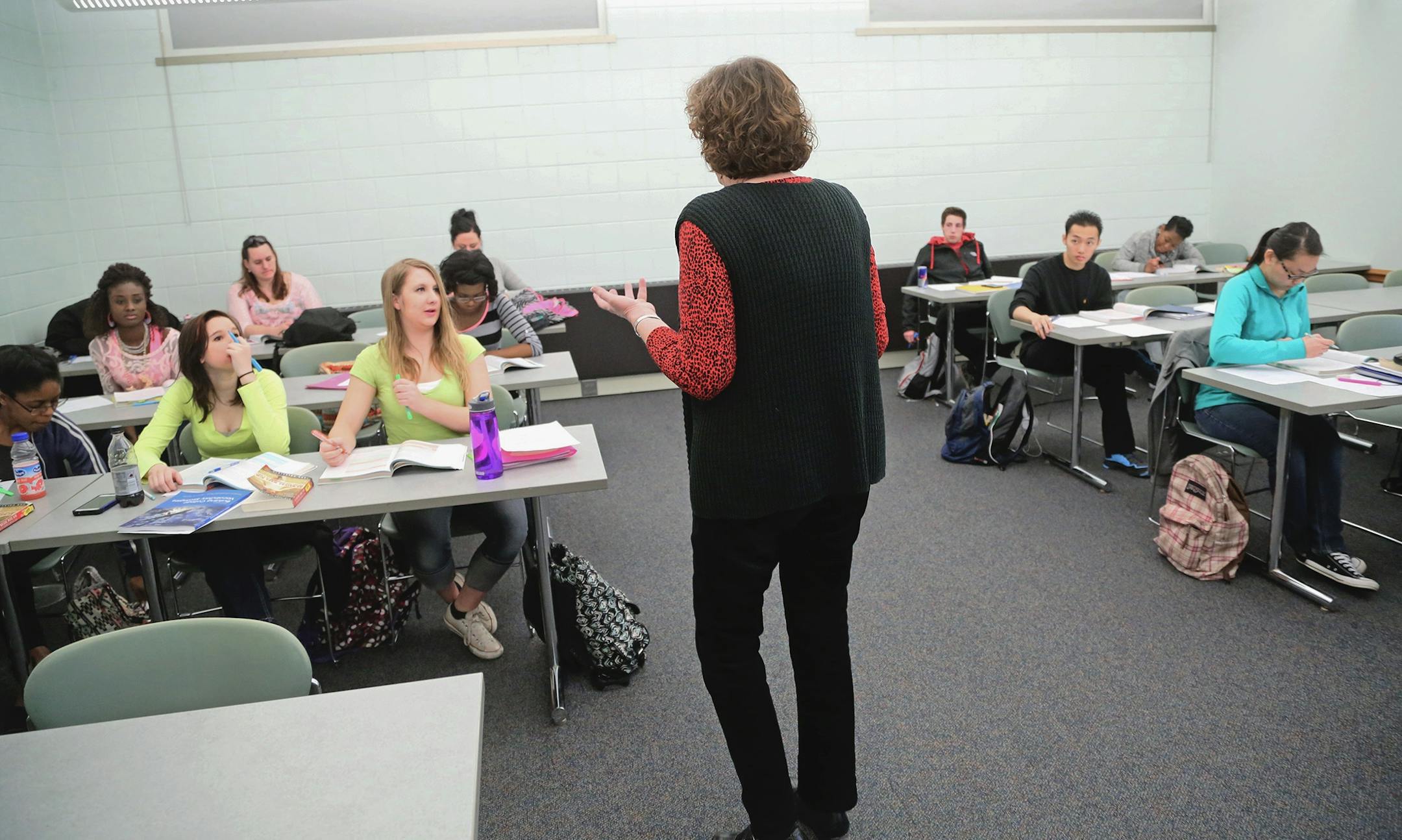 Laurel Watt is worried that proposed legislation would eliminate classes like her developmental reading class at Inver Hills Community College, that teach reading skills to struggling students -- half of the students in her class who are non-native English speakers. Here, Watt helps explain to students how to figure out what goes on in the text to enhance their chances of success when reading college level text books Tuesday, March 17, at Inver Hills Community College in Inver Grove Heights, MN.