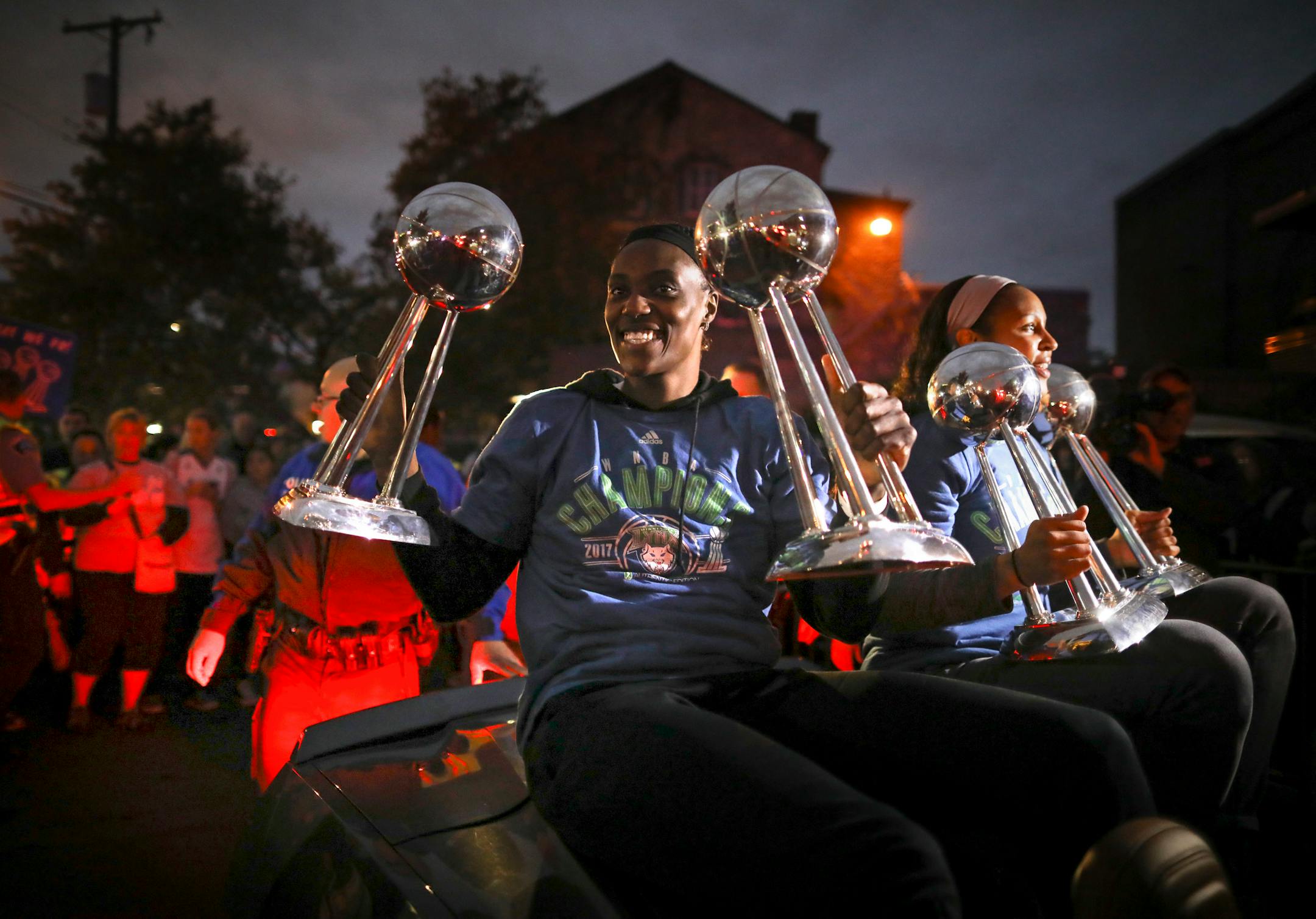 Minnesota Lynx players Sylvia Fowles, left and Maya Moore held up all four WNBA Championship trophies as they arrived at Williams Arena for their title celebration Thursday night.