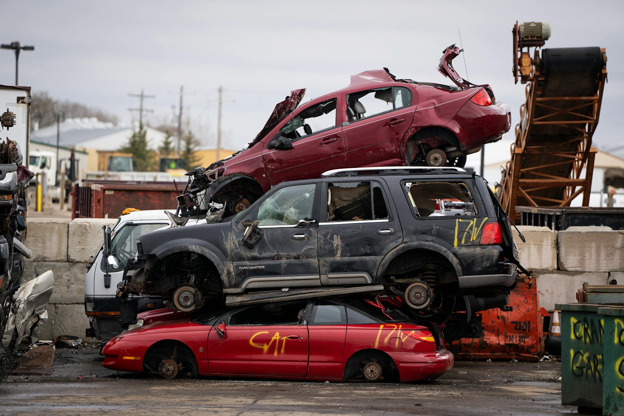 Cars are piled up outside the metal recycling facility at Dem-Con Companies Environmental Campus.