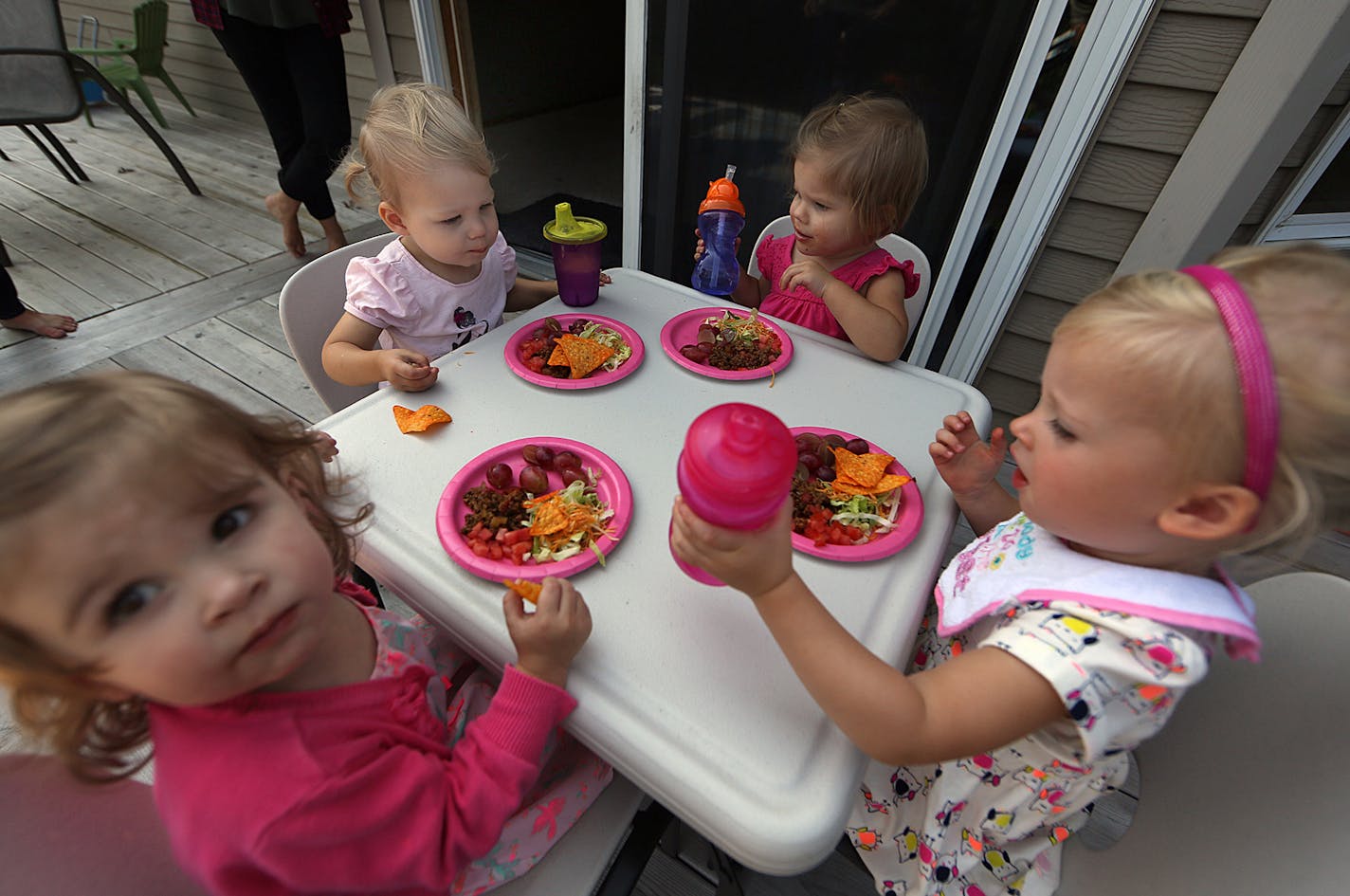 Children had lunch outside on a deck during the playdate.