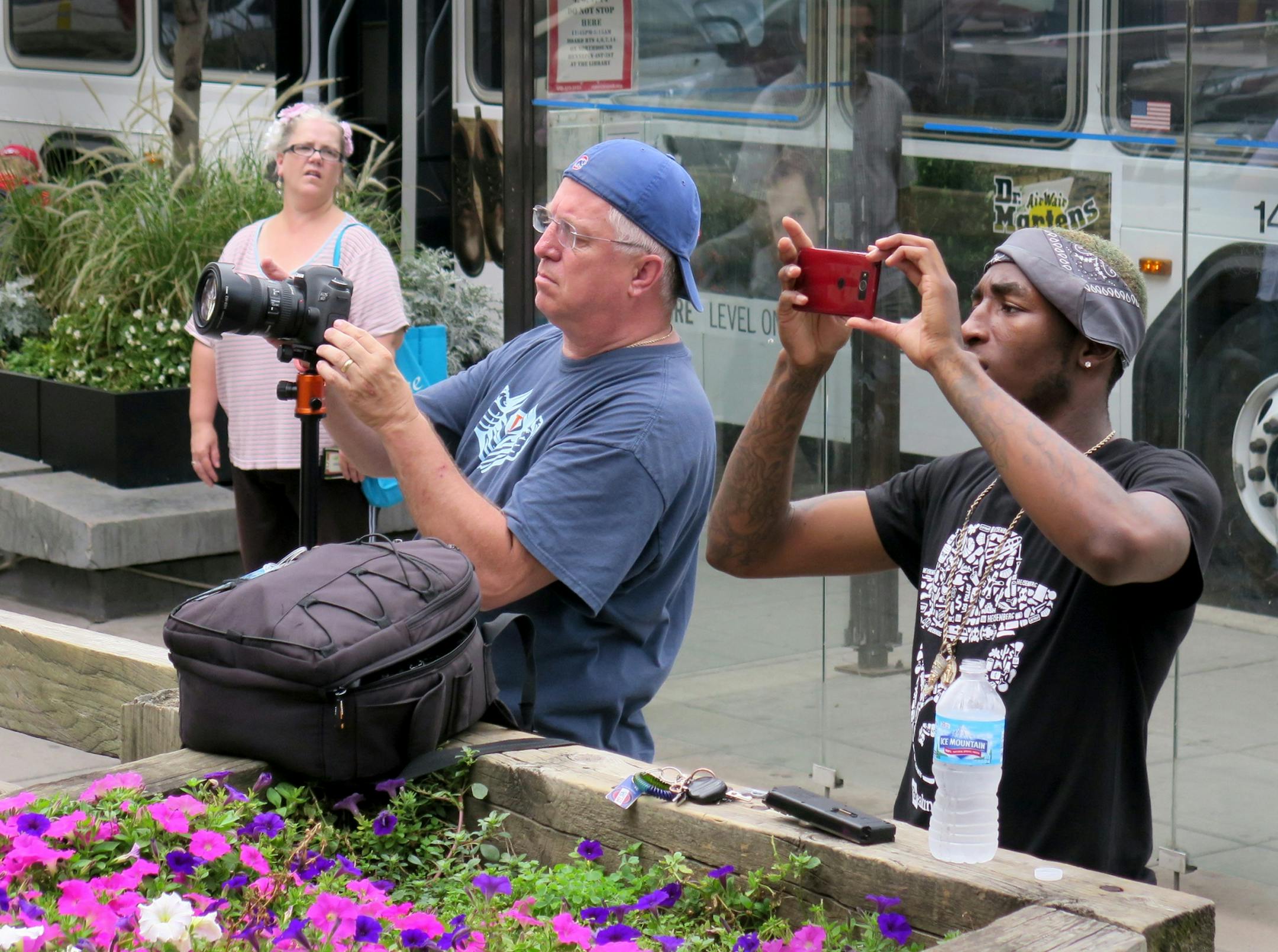 The Bob Dylan mural nears completion, Friday, Sept. 04, as spectators stop at 5th and hennepin to shoot photos