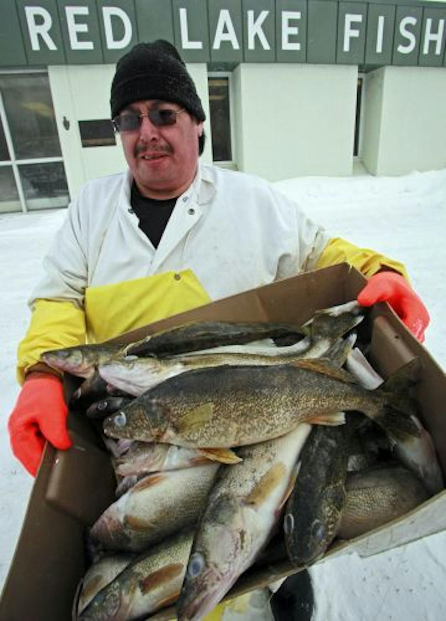 Plant foreman Pete English held a box of walleye in front of the Red Lake Fisheries building.