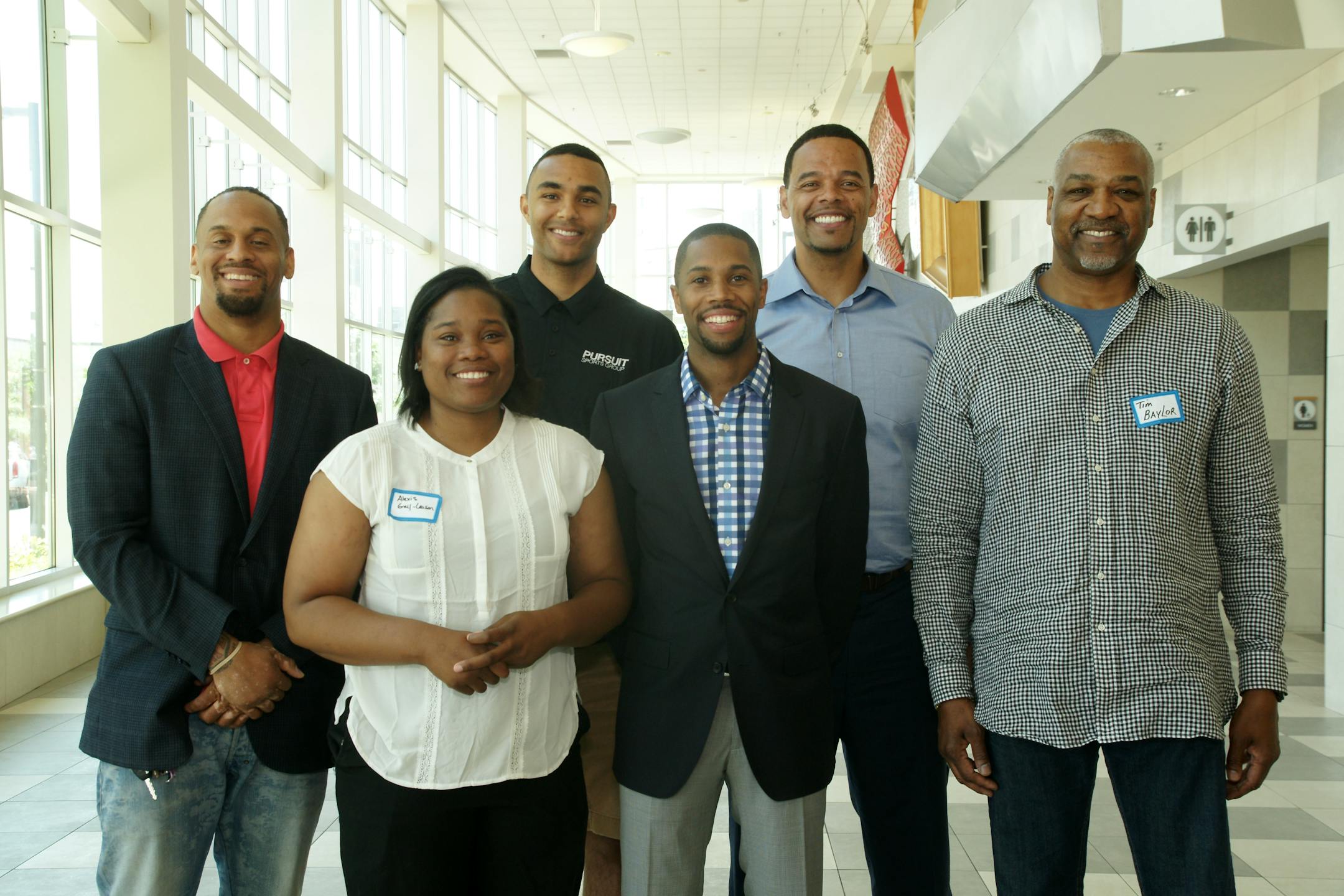 Former professional athletes told kids and coaches to learn early about personal finance and how to save and spend wisely, regardless of income, at a forum sponsored by Romone Penny's Pursuit Sports Group at the Colin Powell Youth Center in Minneapolis. Pictured (clockwise) are Zacharia Oluwabankole Babington-Johnson, director of audit at Thor Construction; Realtor and investor Daniel Coleman; John Thomas of Lifetime Fitness; developer Tim Baylor, Romone Penny and high school coach Alexis Gray, a former WNBA player. Photo: Gregg Felsen
