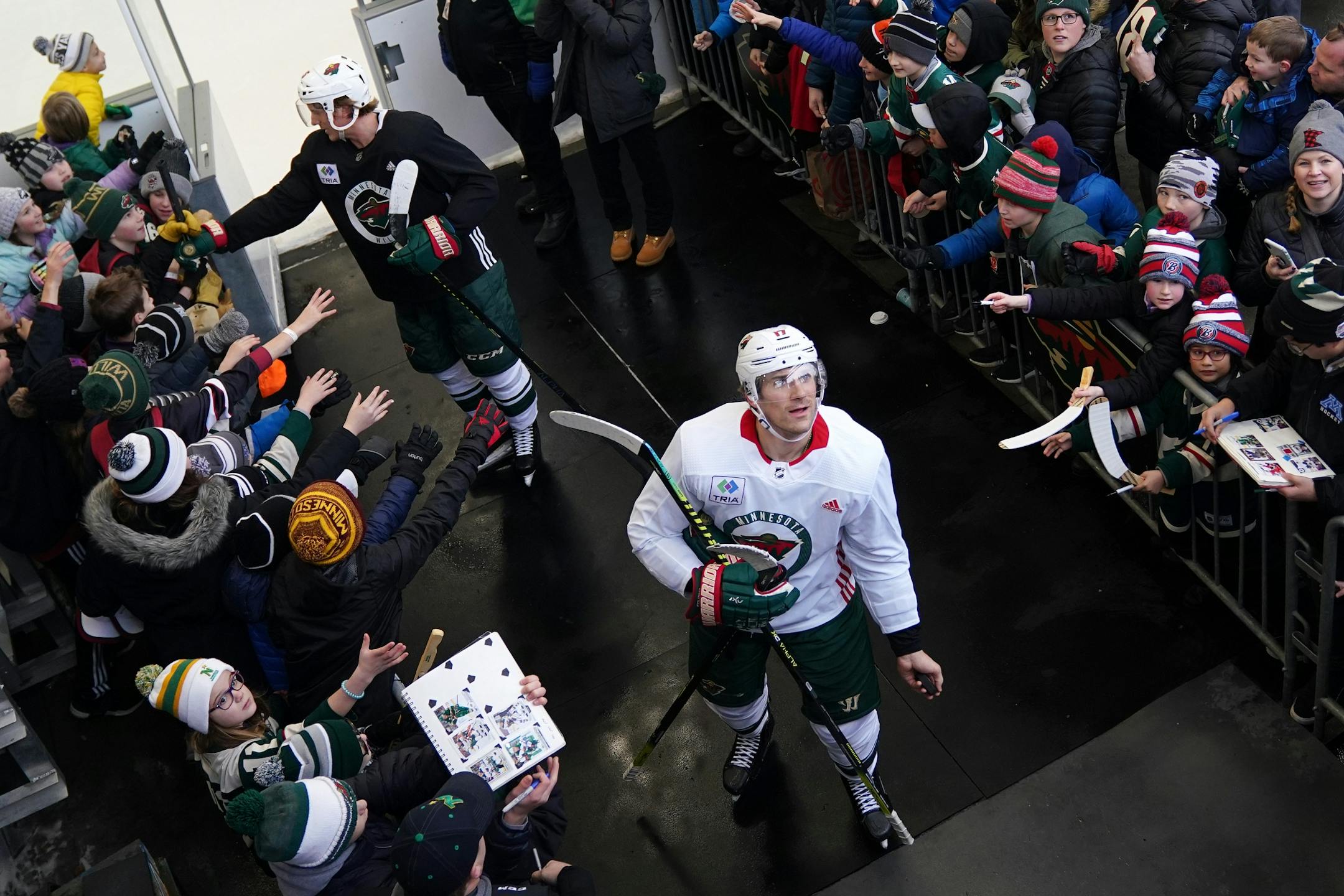 Minnesota Wild left wing Marcus Foligno (17) looked to throw a puck to a fan following the Wild's outdoor practice Thursday.