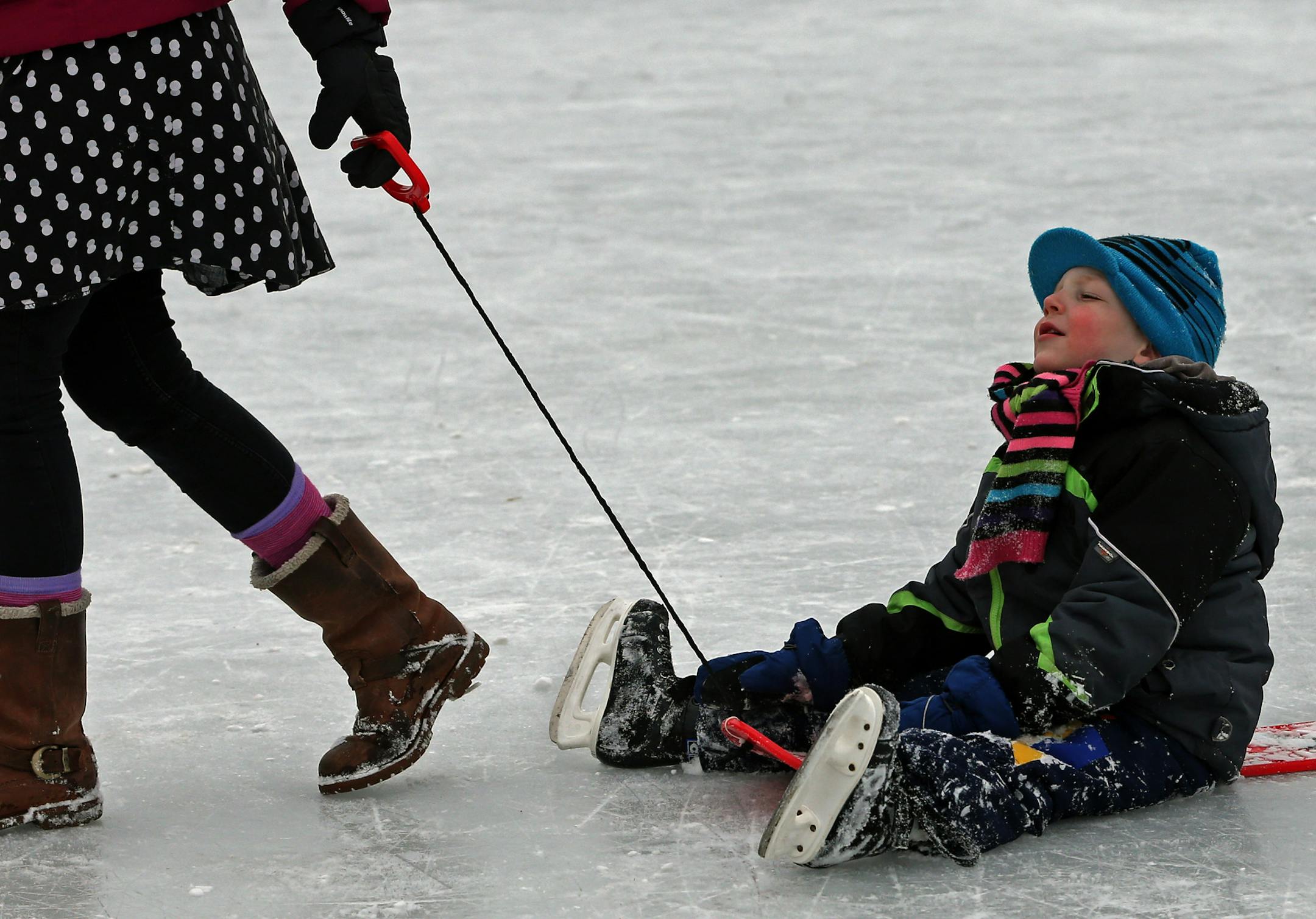 Hilde Hoffmann pulled her 4-year-old son, Philip, to the warming house on the Lake of the Isles skating rink on Saturday in Minneapolis. The Hoffmanns are visiting from Dortmund, Germany.