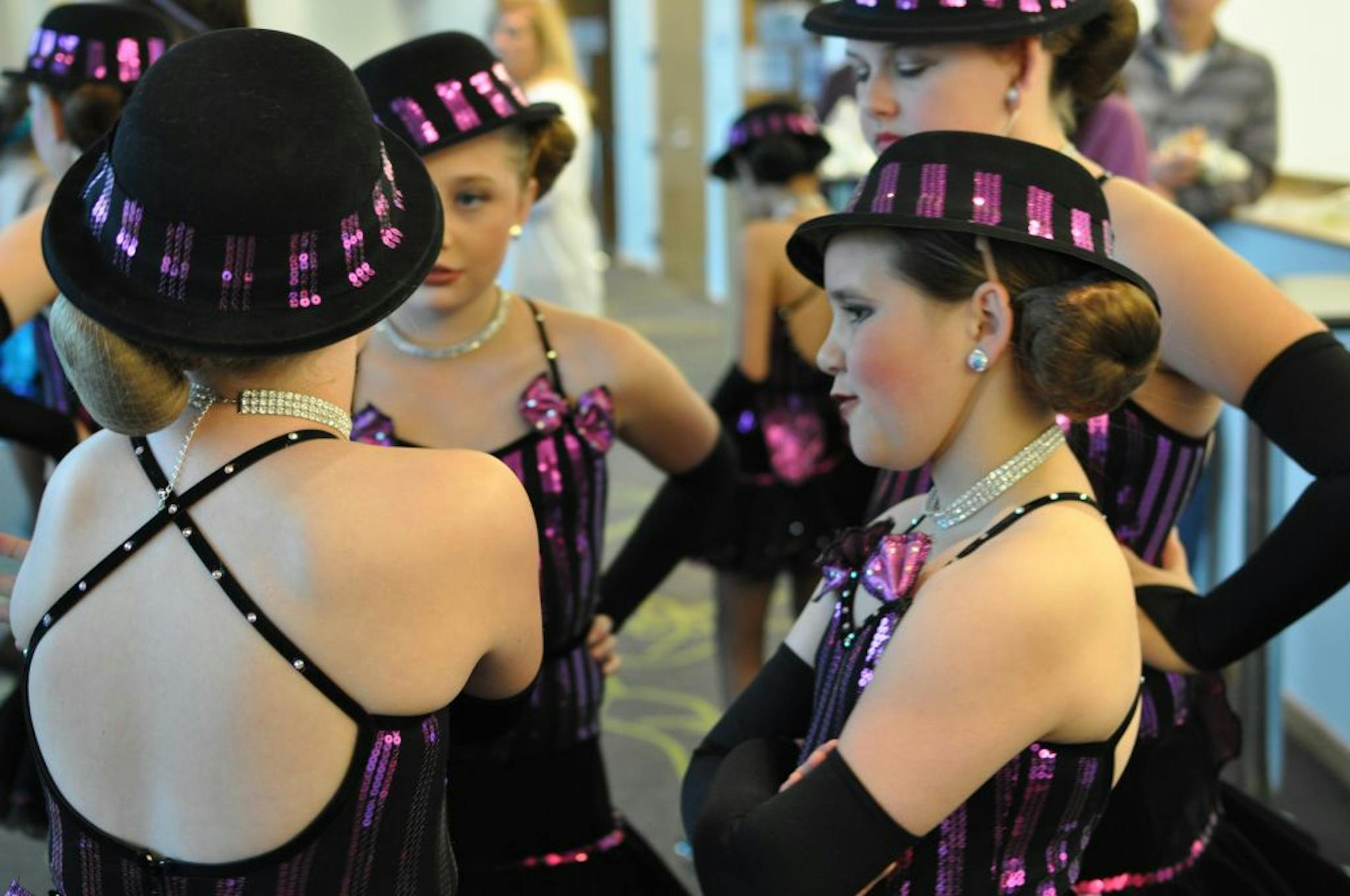Eleven-year-old Mya Braun, right, of Shakopee, waited with others in her group to perform at the Masquerade dance competition at Burnsville Performing Arts Center.