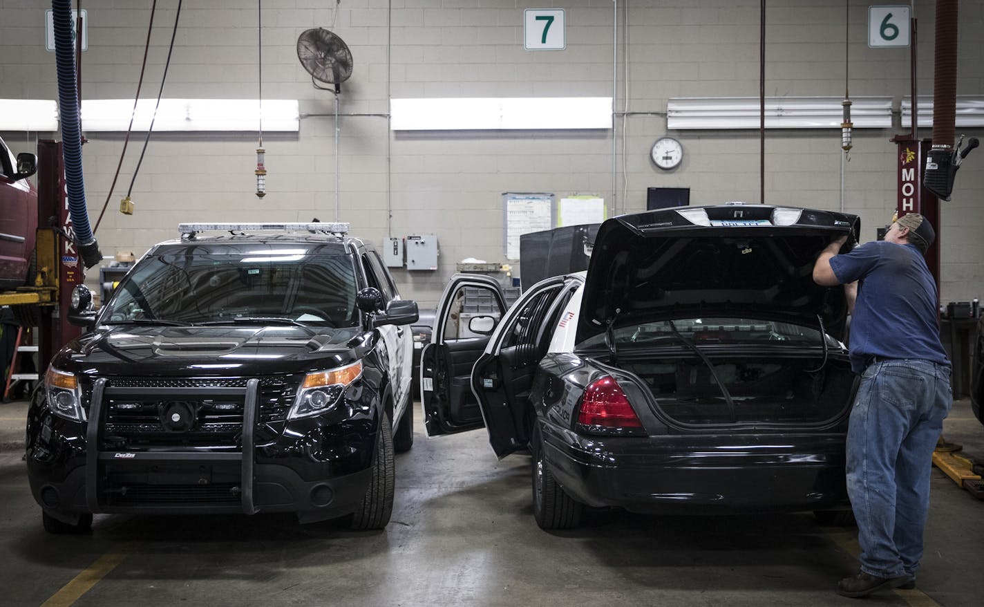 Public works mechanic Christopher Decker removed police lights from the back of an old Crown Vic police car that was being stripped and sold at the Royalston Maintenance Facility on Tuesday, November 29, 2016, in Minneapolis, Minn. At left is the new explorers ] RENEE JONES SCHNEIDER &#x2022; renee.jones@startribune.com