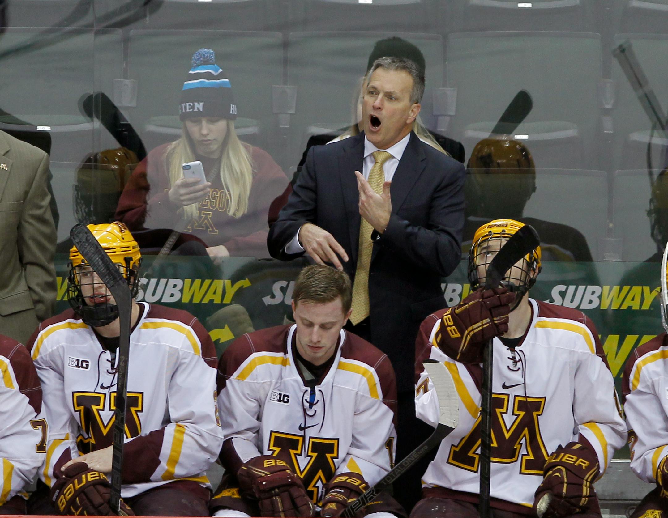 Minnesota head coach Don Lucia disagrees with a call during the third period of a college hockey game against Ohio State in the semifinals of the Big 10 Conference tournament in St. Paul, Minn., Friday, March 21, 2014. Ohio State won 3-1. (AP Photo/Ann Heisenfelt)