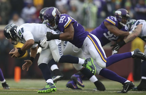 Vikings defensive end Danielle Hunter (99) tackled Seahawks quarterback Russell Wilson (3) for a six yard loss in the second quarter Sunday.