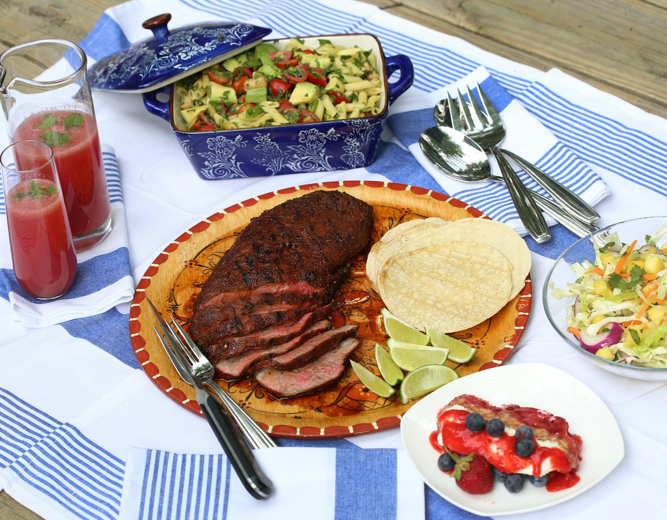 The tastes of a backyard July 4th, clockwise from top left: Watermelon-Cucumber and Vodka Cooler; Spinach and Avocado Penne Pasta Salad; Spicy Pineapple Slaw; Strawberry Pretzel Terrine, Chili-Lime Flat Iron Steak. (Jessica J. Trevino/Detroit Free Press/TNS) ORG XMIT: 1234128