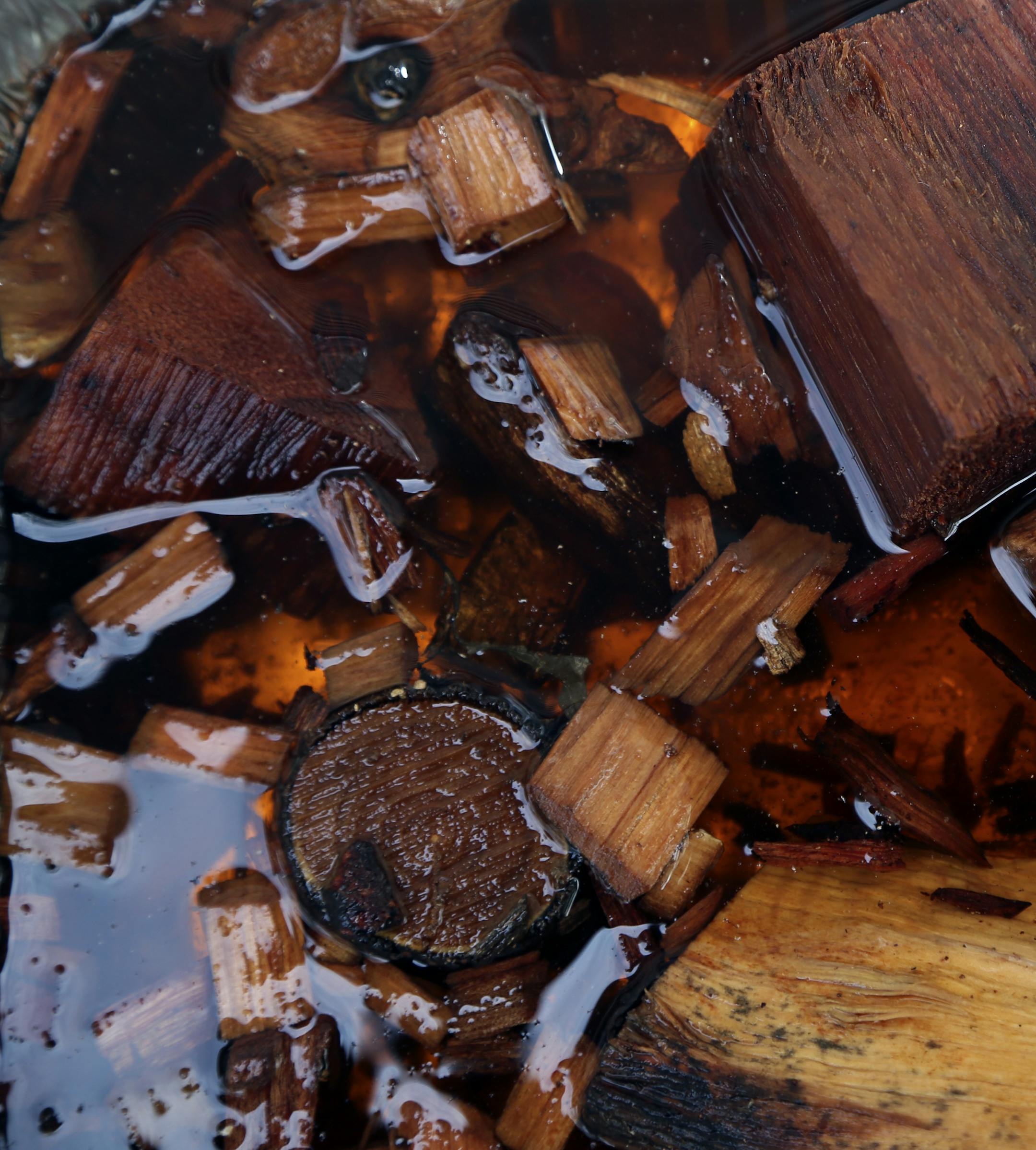 Wood chips are soaked in water before going on to the smokers for a slow burn during Smokapalooza 2013, on the deck of the Pupel family residence Saturday, May 26, 2013 in Plymouth, MN.](DAVID JOLES/STARTRIBUNE) djoles@startribune How do you learn the intricacies and nuances of user a smoker? By having lots and lots of experiments going on at one time. How do you do that? By gathering 10 families, smokers and grills at the ready, for Smokapalooza. Everyone learns, by successes and failures, and