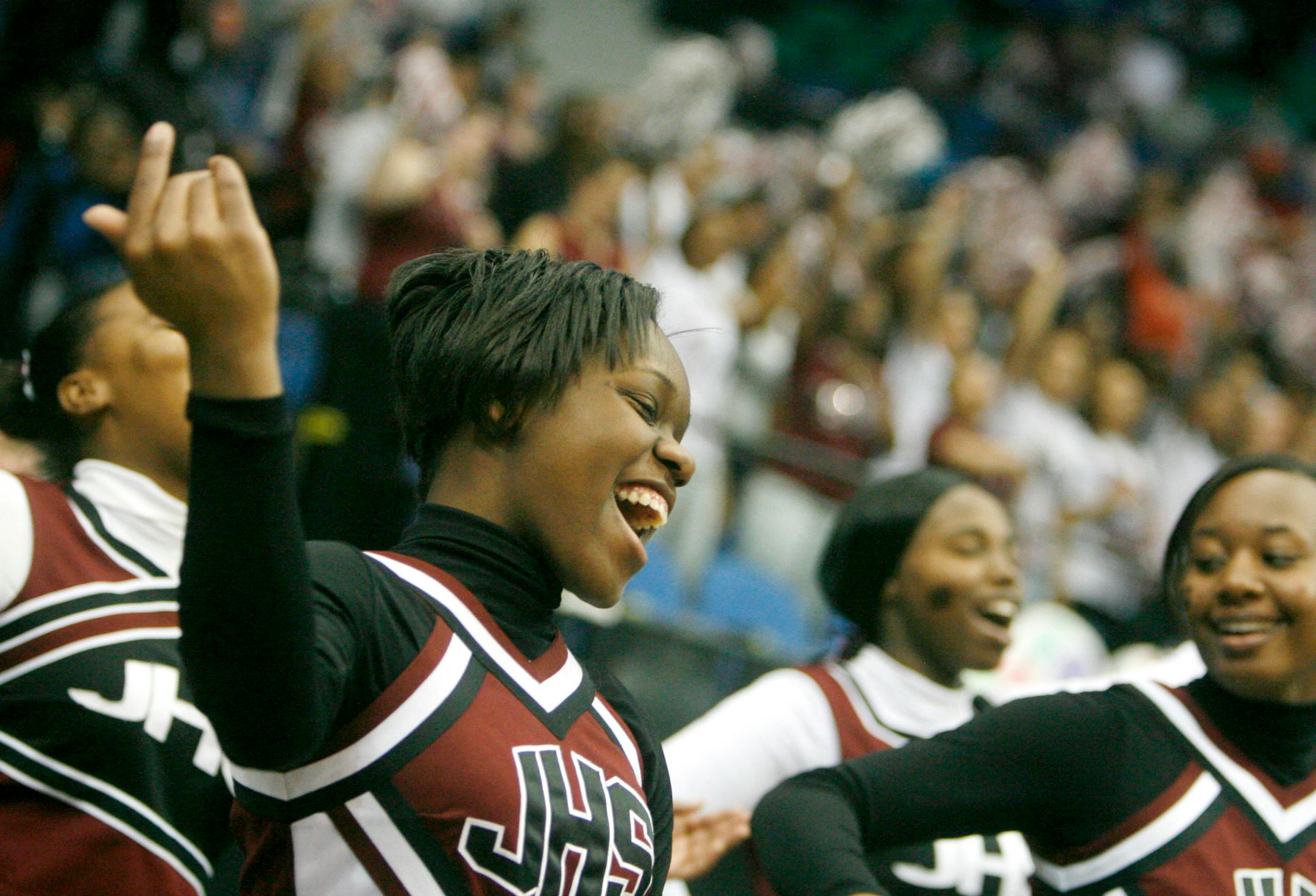 Johnson High cheerleader T'Keiah Lane cheers on her team during second half action of Johnson's 80-55 win..