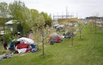 What began in March as a small camp consisting of about a couple dozen homeless adults has now swelled to more than 100 residents in tents. Known as "