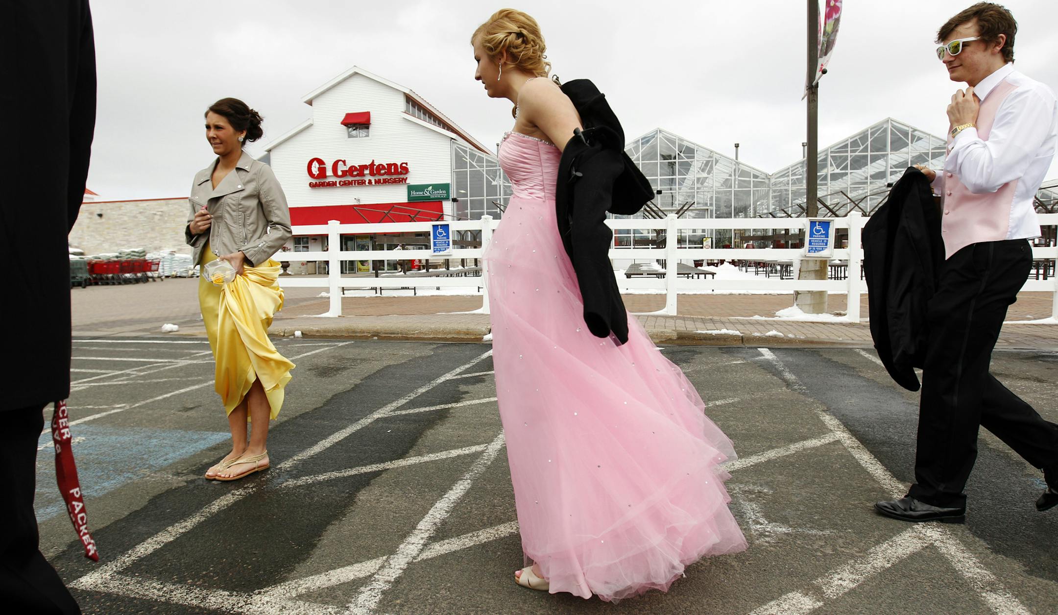 South St. Paul High School students, from left to right, Rachel Fronk, 18, Kristyn Waldhauser, 16, and Christian Rund, 16, arrive at Gerten's greenhouse in Inver Grove Heights, Friday April 19, 2013, to take their pre-prom photos. (Genevieve Ross/Special to the Star Tribune) ORG XMIT: 4SNOW042013