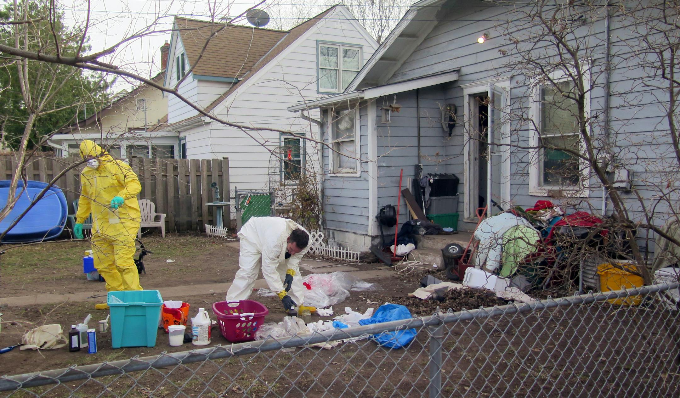 Police clean out debris from a meth lab that was discovered in the basement of 5137 Abbott Av. S., Minneapolis, on Friday, April 11, 2014.