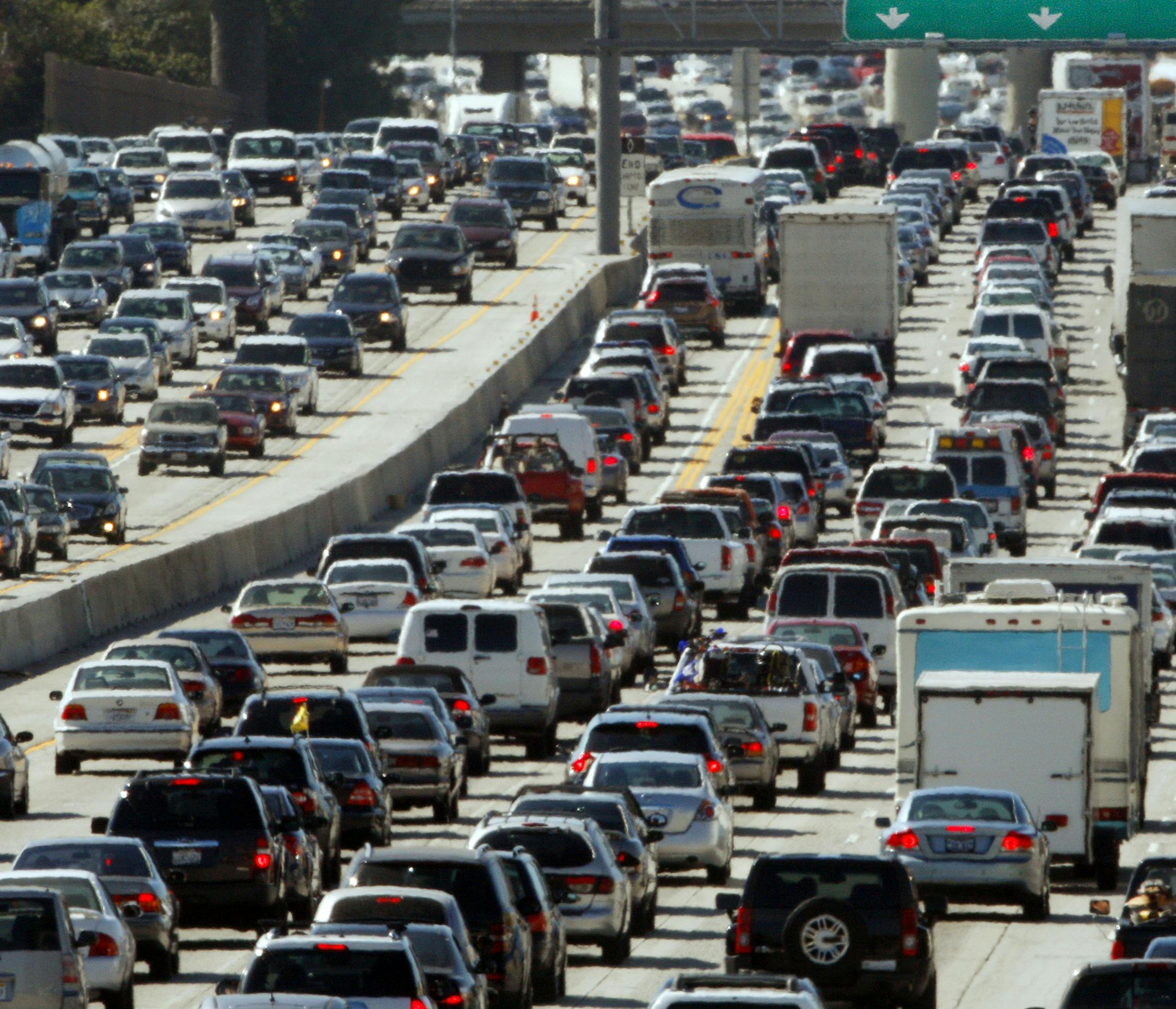 FILE - In this May 28, 2010 file photo, the rush hour commute starts in early afternoon and with greater intensity as traffic is jammed in both directions on Interstate 405 on the Westside of Los Angeles as commuters and vacationers hit the road. Cheaper gas won&#xed;t be enough to spur many more road trips this summer. Americans are too worried about their jobs and the economy to feel relief. Economists and tourism experts are expecting only a small uptick in summer travelers. Gas prices are lo