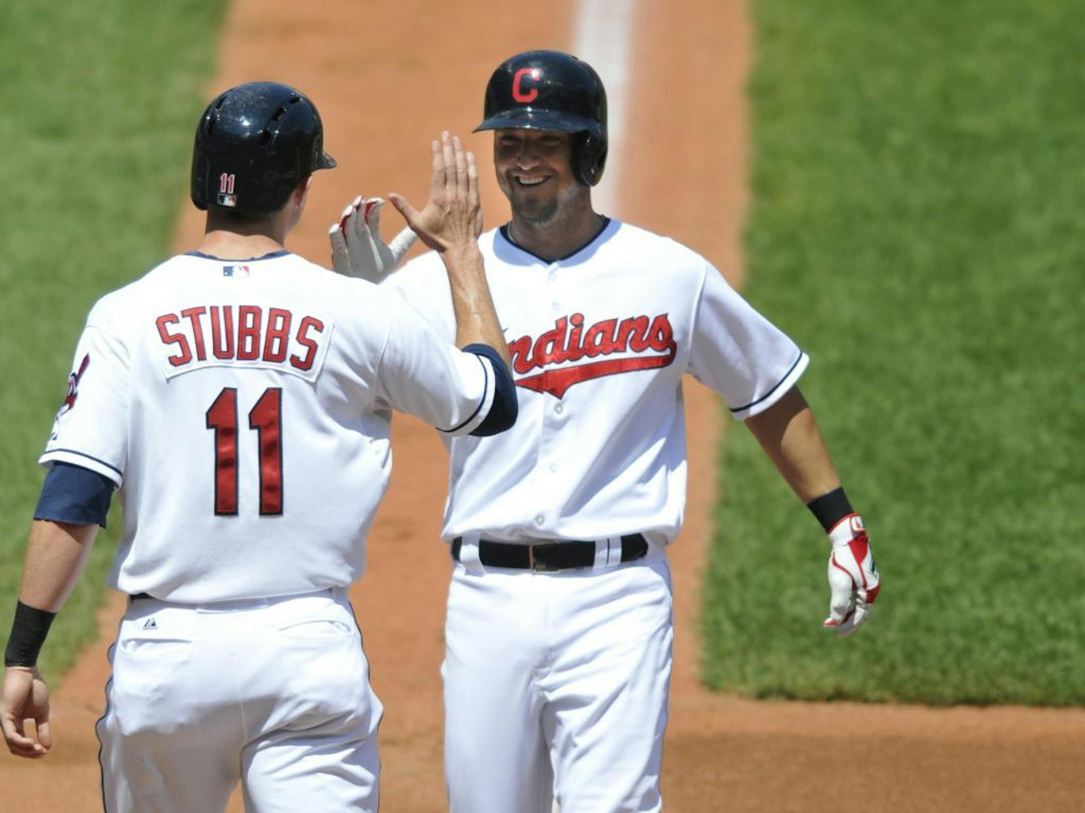 Cleveland Indians right fielder Ryan Raburn, right, celebrates his two-run home run with center fielder Drew Stubbs against the Chicago White Sox in the third inning of a baseball game, Thursday, August 1, 2013, in Cleveland.