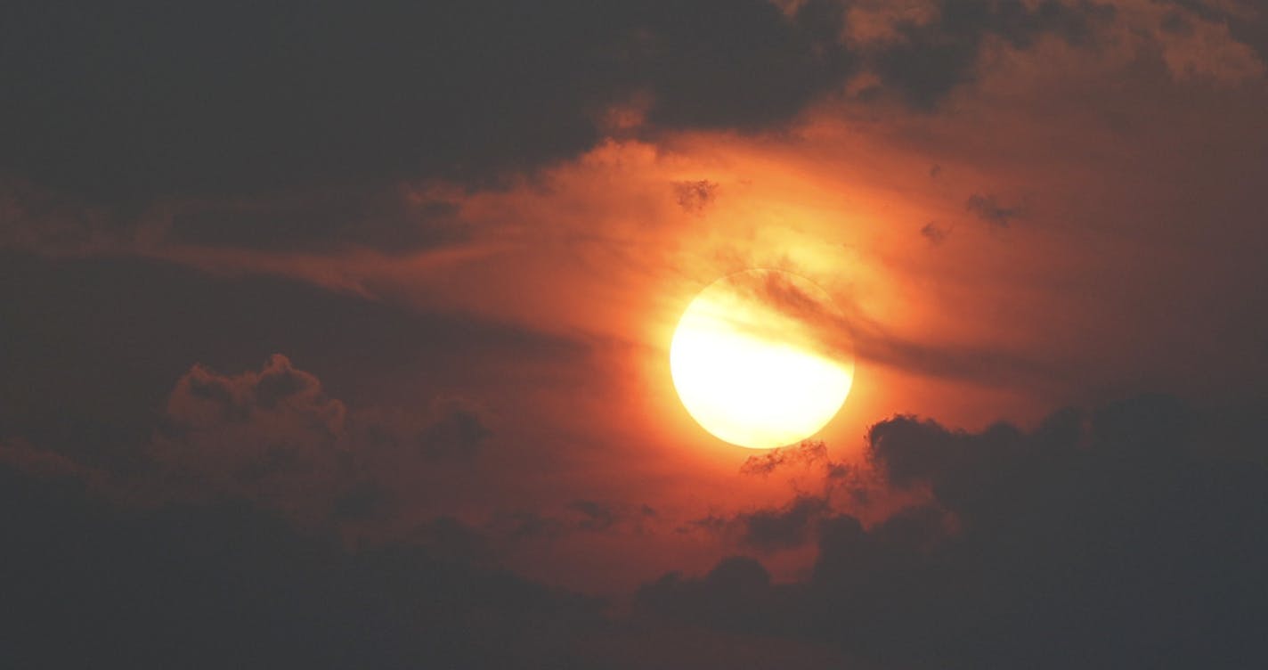 A smoky haze obstructs the sun as it sets behind the Rocky Mountains that usually can be seen late Monday, Aug. 20, 2018, in Denver. Smoke from the countless wildfires burning in western Canada as well as the American West has forced the issuance of air quality alerts across the region. (AP Photo/David Zalubowski)