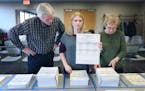 Rick Winters, left, Amanda Murr, center, and Romayne Houle, cq, right, sorted and counted ballots for the St. Paul City Council Second Ward race, Mond