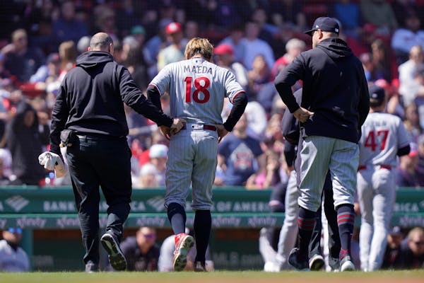 Kenta Maeda was helped off the field after taking a line drive off his ankle at Boston on Thursday.