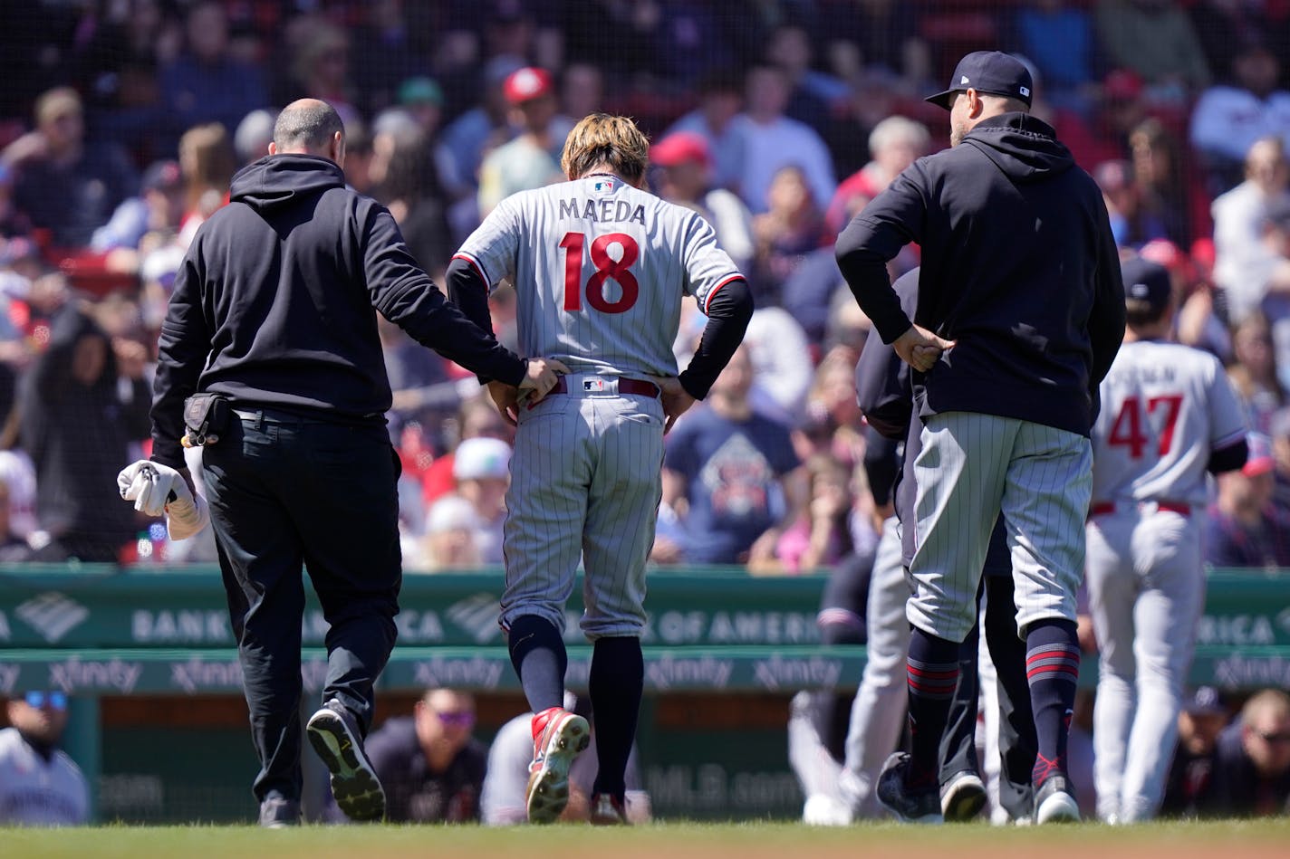 Kenta Maeda was helped off the field after taking a line drive off his ankle at Boston on Thursday.