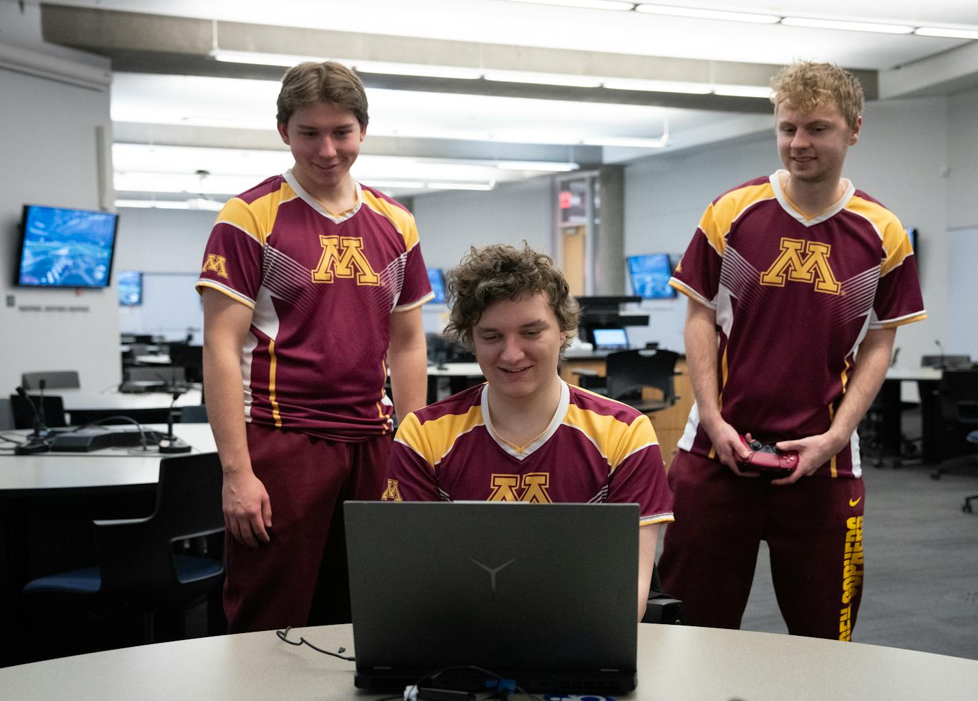 Members of the University of Minnesota Twin City's Rocket League team from left, Jakson Coffin, Braden Raddatz and Zachary Elliott connect a laptop in a classroom on the campus in Minneapolis, Minn., on Tuesday, Dec. 12, 2023.