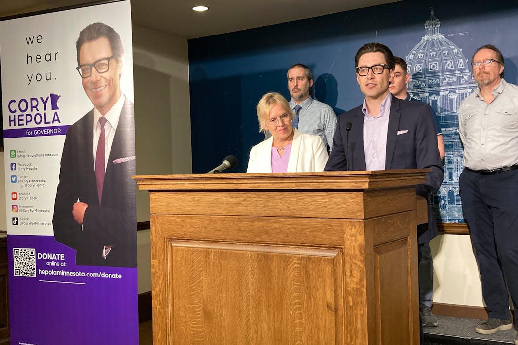 Former broadcaster Cory Hepola, center, who’s running for governor with the upstart Forward Party of Minnesota, named school administrator Tamara Uselman, left, as his running mate during a news conference Tuesday, May 27, 2022, at the State Capitol in St. Paul.