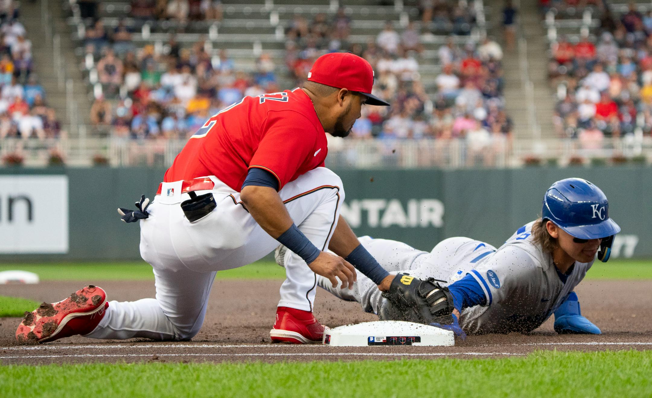Minnesota Twins first baseman Luis Arraez (2) attempts to tag out Kansas City Royals shortstop Bobby Witt Jr. (7) in the first inning.