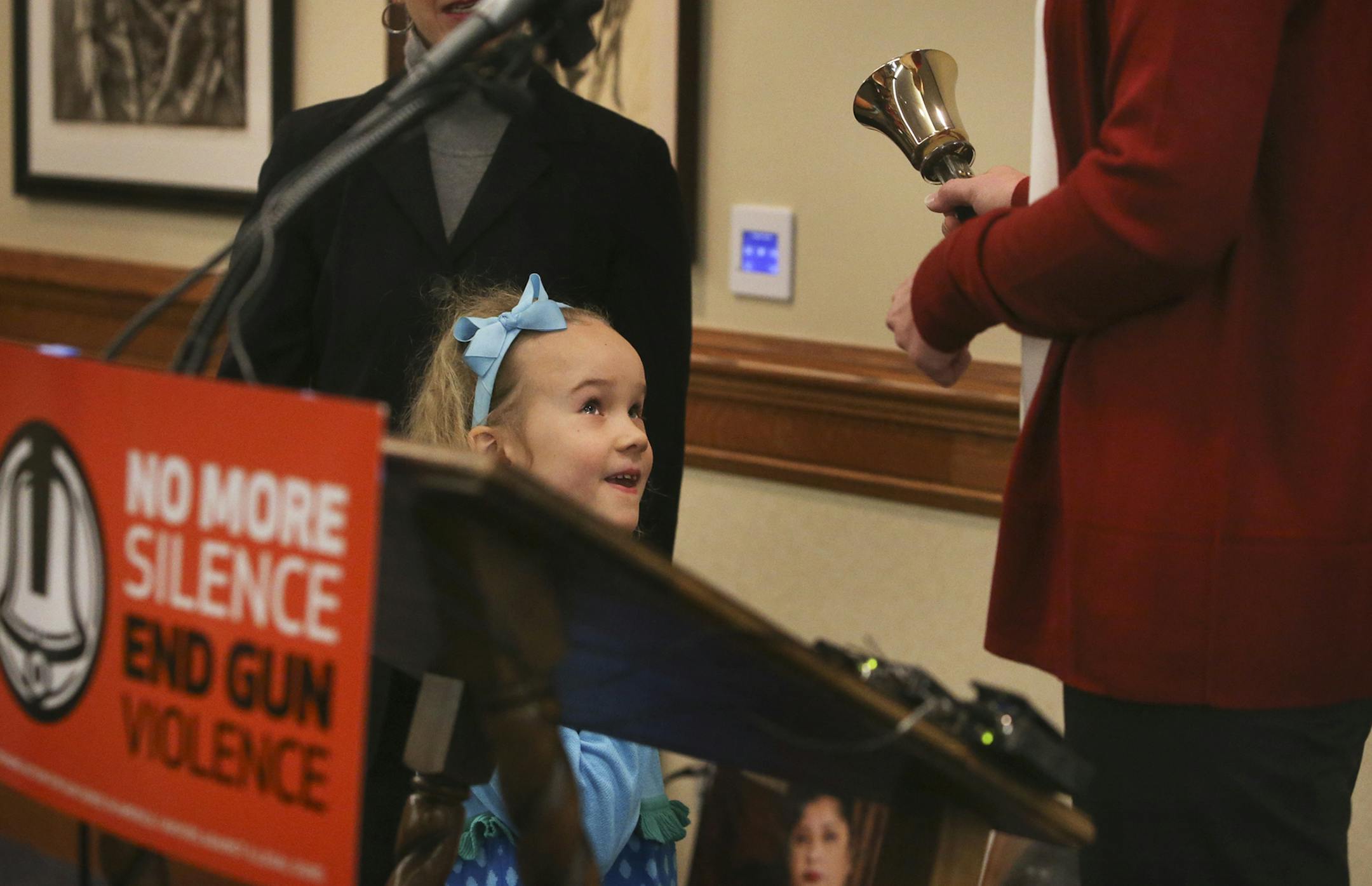 Here, Anna Brock, 7, looks up at her mom Marit Brock, as Brock rang a bell 26 times in honor of the 20 children and six adults murdered one year ago at Sandy Hook Elementary School in Newtown, CT, as well as all victims of gun violence, Saturday, Dec. 14, 2013, during a Memorial at Westminister Presbyterian Church in Minneapolis, MN.](DAVID JOLES/STARTRIBUNE) djoles@startribune.com Moms Demand Action for Gun Sense in America - Minnesota Chapter hosted a memorial event in honor of the 20 children