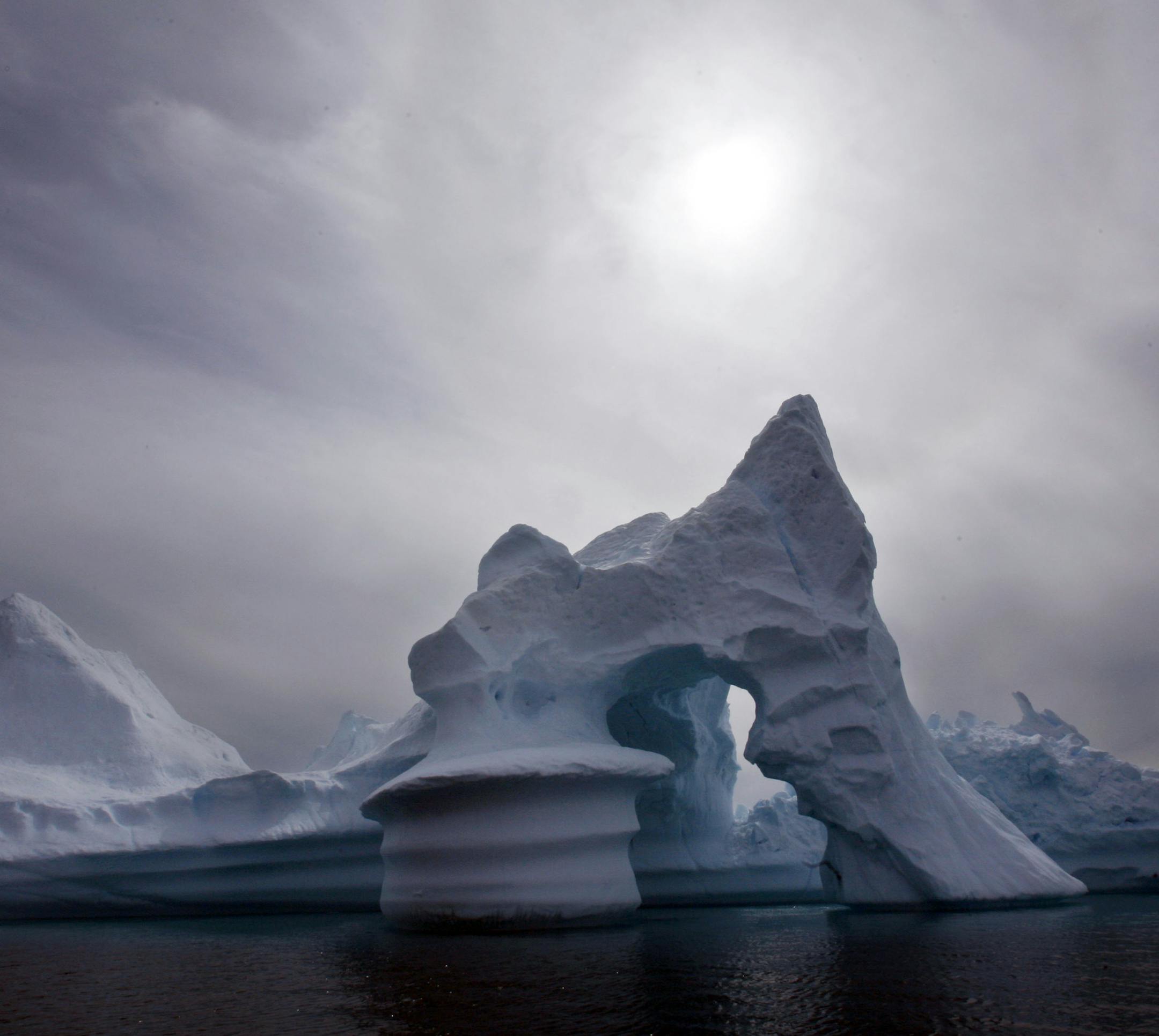 ** FILE ** An iceberg melts off Ammassalik Island in Eastern Greenland in this July 19, 2007 file photo. A record amount of Greenland's ice sheet melted this summer _ 13 billion tons more than the previous high mark _ U.S. scientists are reporting this week in an ominous new sign of global warming. (AP Photo/John McConnico, file) ORG XMIT: NY349