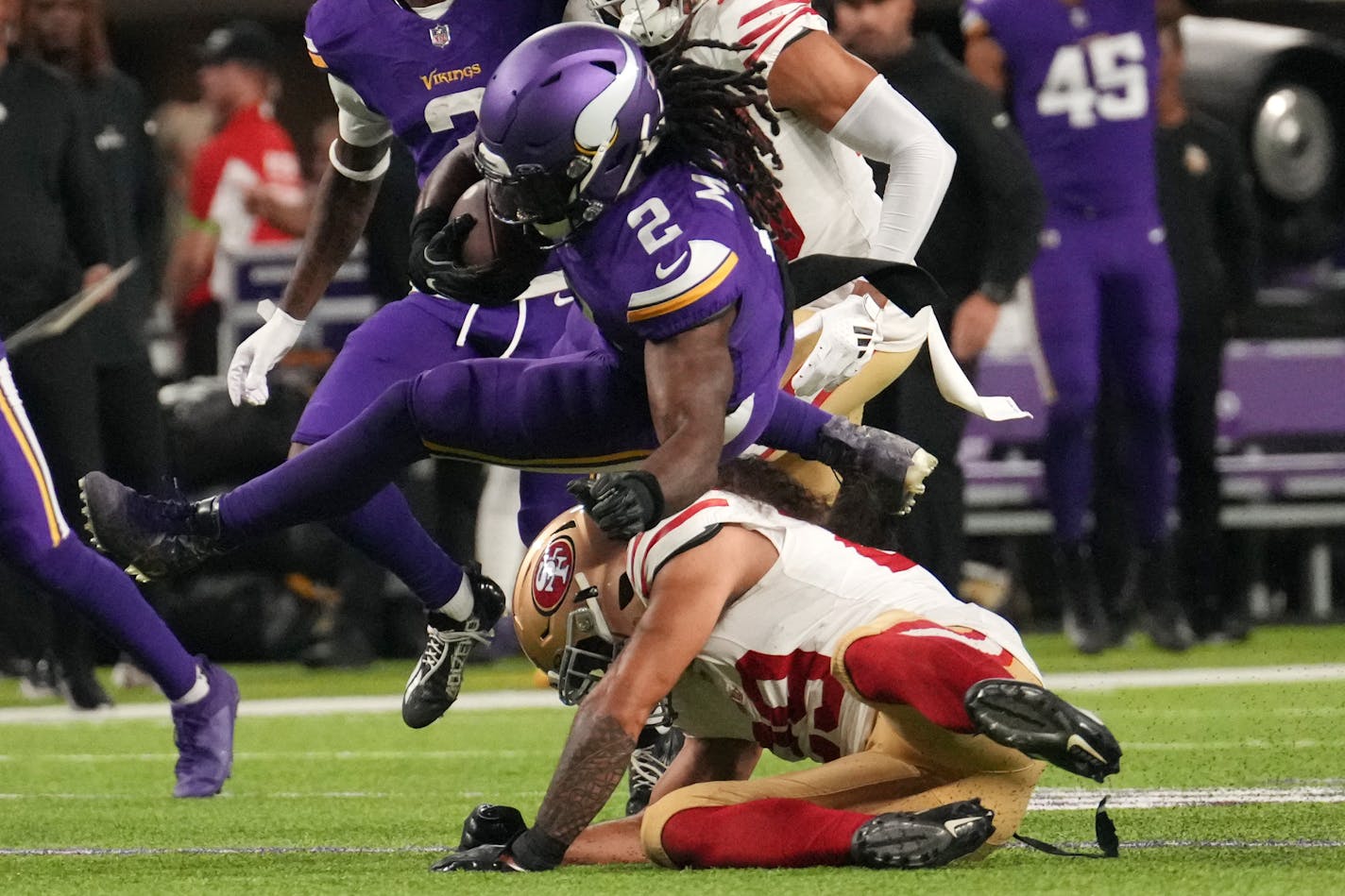 Minnesota Vikings running back Alexander Mattison (2) is tripped up in the first quarter.