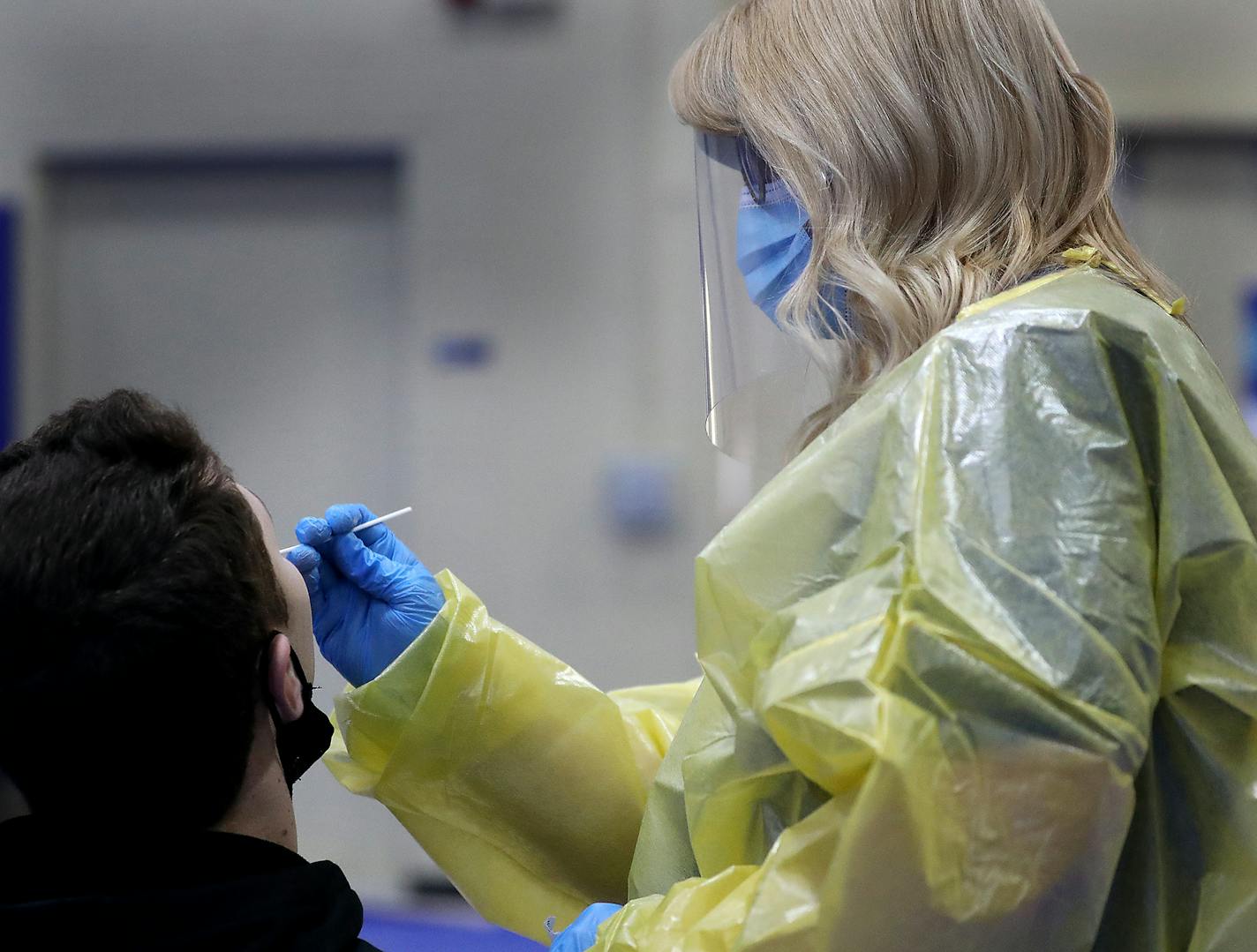 Jennifer Schmidt, a traveling RN, conducts a nasal antigen test on a student at the University of Wisconsin Eau Claire Monday in Eau Claire, WI. The test is for those who are asymptomatic and takes about 20 minutes from the time the swab is taken until the results come back. UW-Eau Claire has a comprehensive COVID tracking program and can quickly test students and faculty. ] DAVID JOLES • david.joles@startribune.com Monday, Nov. 2, 2020 in Eau Claire, WI. Separated by two scenic rivers, the simi