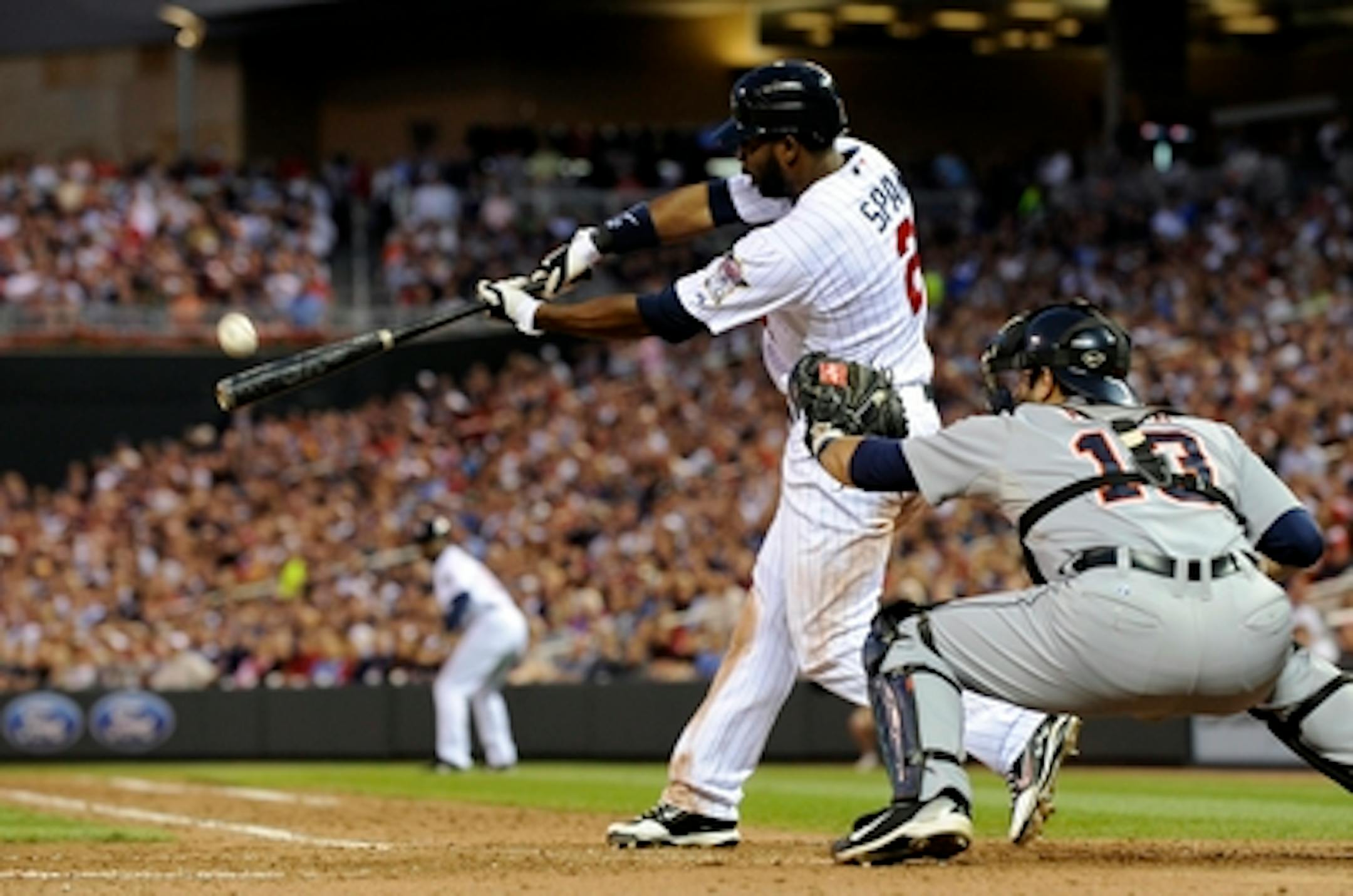 Minnesota Twins' Denard Span hits a three-run triple off Detroit Tigers Fu-Te Ni in the fifth inning, his third triple of the  baseball game Tuesday, June 29, 2010 in Minneapolis. Catching is Tigers' Alex Avila. (AP Photo/Jim Mone)