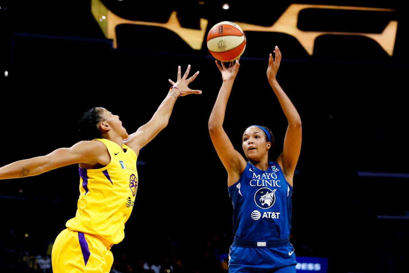 WNBA Rookie of the Year Napheesa Collier, right, shoots while defended by Los Angeles Sparks' Candace Parker during the first half of a game last season.