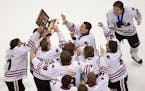 Lakeville North players hoisted their championship trophy after beating Duluth East in the Class 2A boys' hockey title game in March.