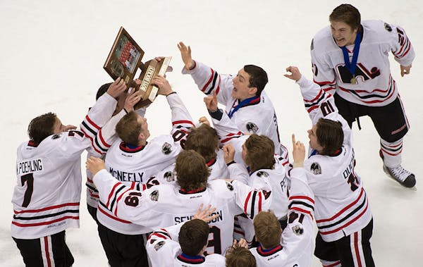 Lakeville North players hoisted their championship trophy after beating Duluth East in the Class 2A boys' hockey title game in March.